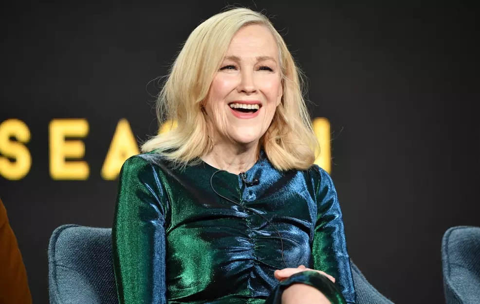 Catherine O'Hara laughing on stage.