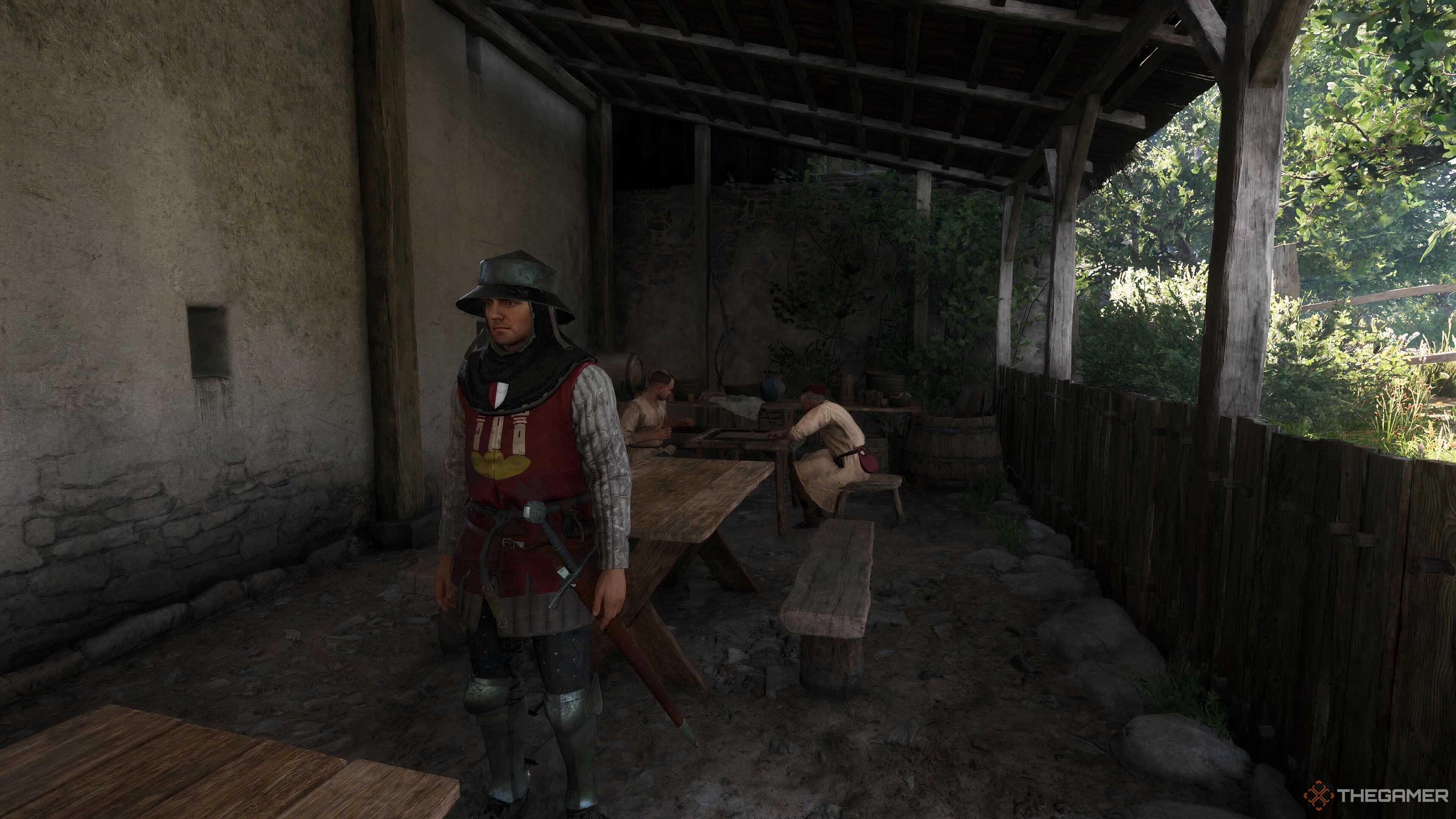 Henry standing by a table in Kingdom Come: Deliverance 2.