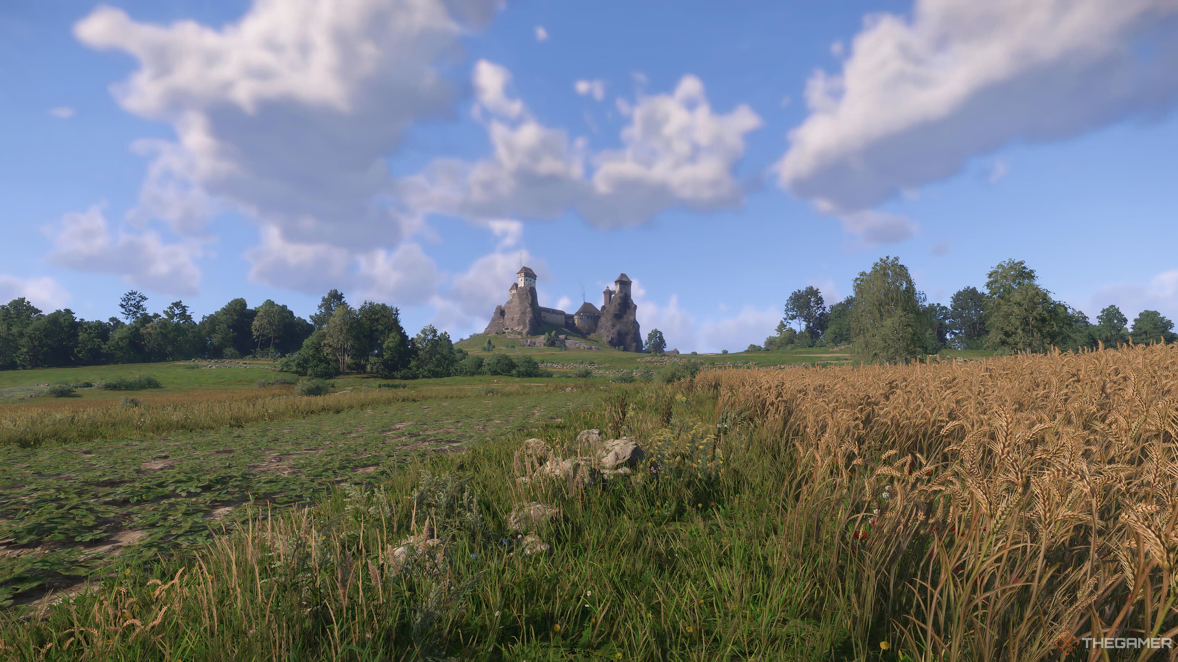 A castle above some fields in Kingdom Come: Deliverance 2.