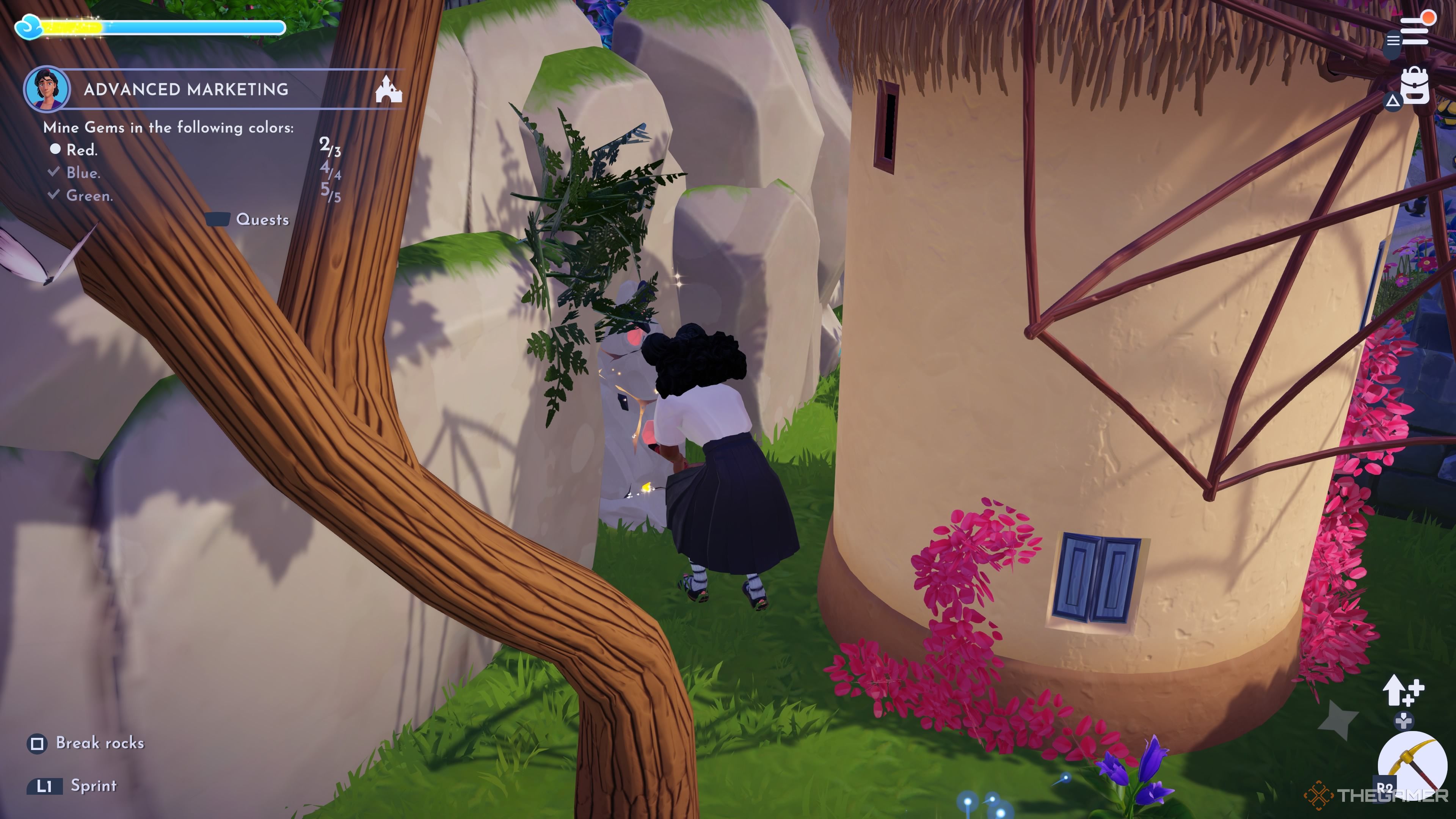 Player character breaking a mining node with red gem pieces on it behind a windmill in Disney Dreamlight Valley.