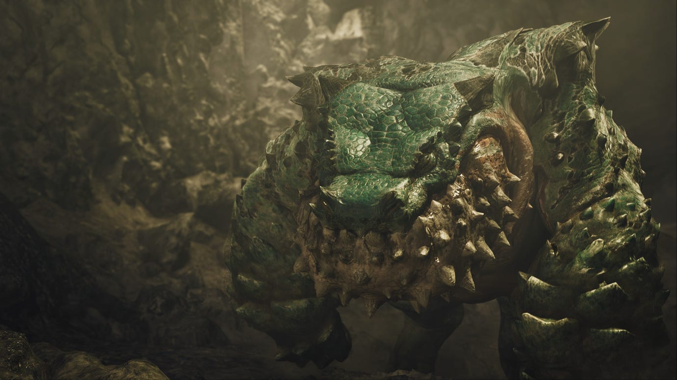 A Monster Hunter Wilds cutscene showing the green Chatacabra up close with a rock wall behind them.