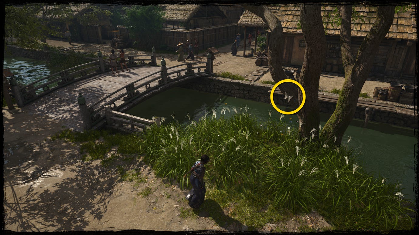 A close-up of a tree next to a bridge in Osaka in Assassin's Creed Shadows, with a yellow circle highlighting the location of a white Origami Butterfly.