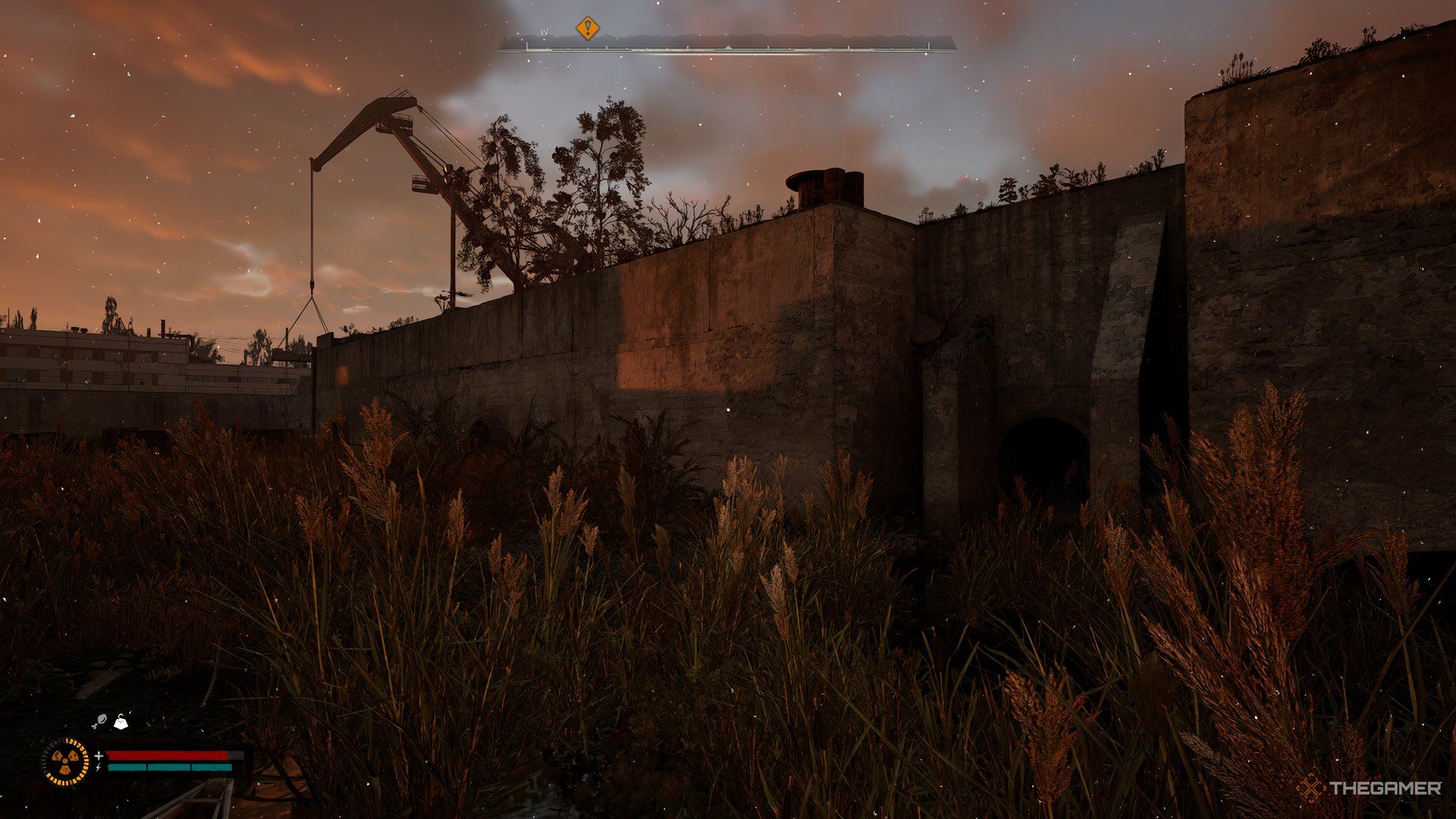 An image showing sever entrance with a crane in the background and plants in foreground.