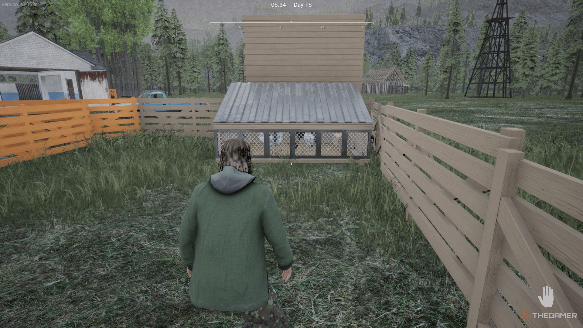 The player is crouching in front of the medium sized coop in Ranch Simulator