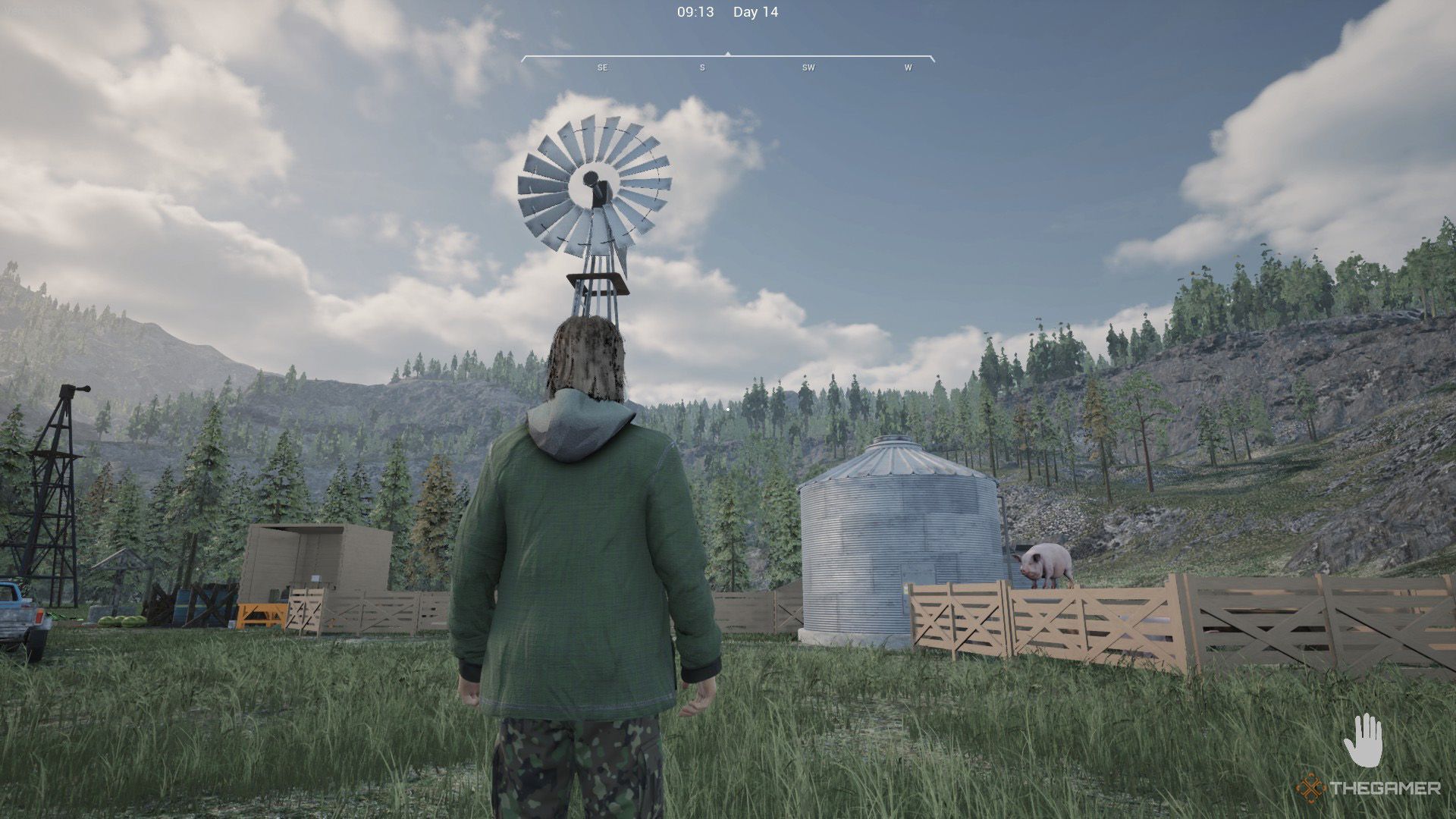 The player is looking at a windmill and the granary in Ranch Simulator