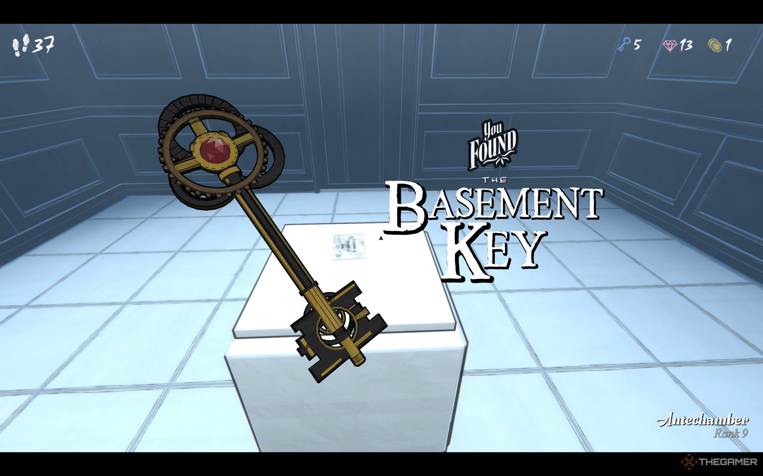 A golden key with a ruby on top in Blue Prince's Antechamber.