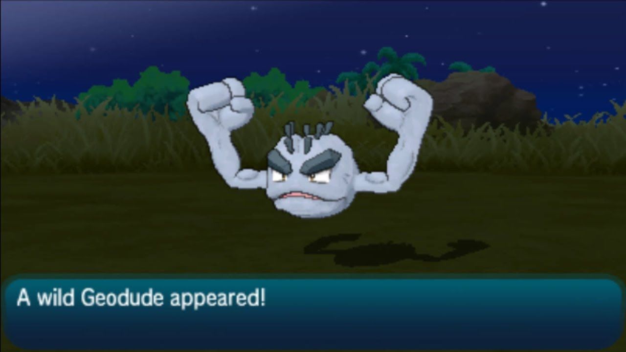 A trainer encounters a wild Alolan Geodude in Pokemon Sun.