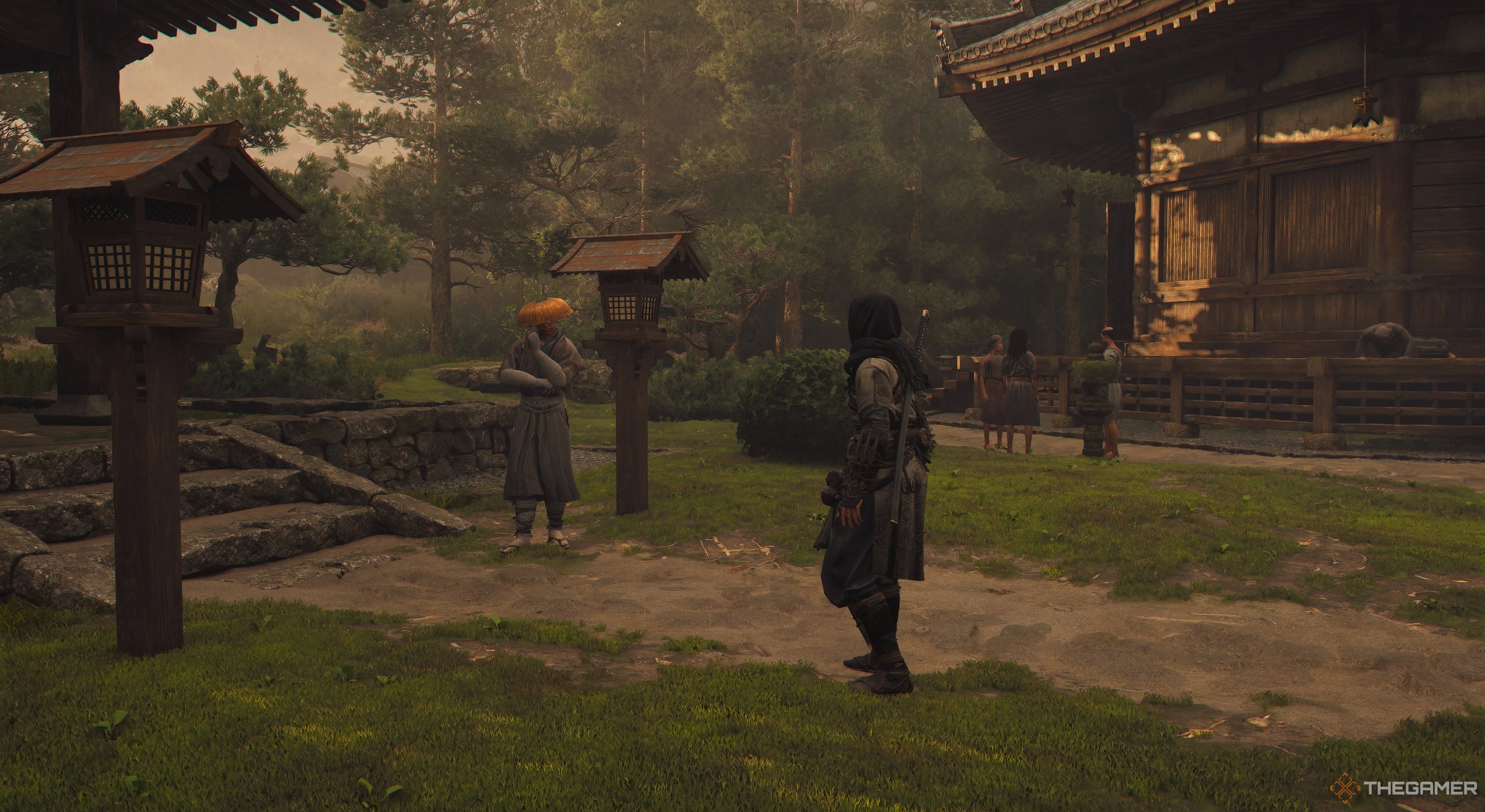 Assassin's Creed Shadows Naoe looking at Kennyo with two NPCs in the background. There's also a temple on right.