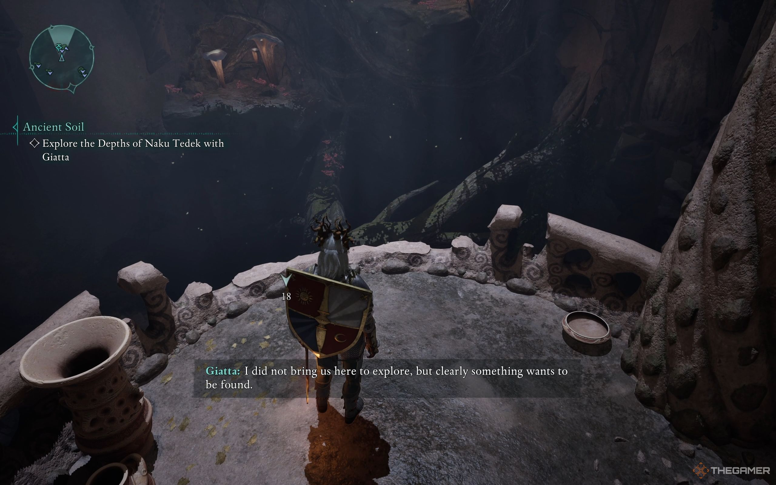 The Envoy stands in a ruined room, with a tree root leading down.