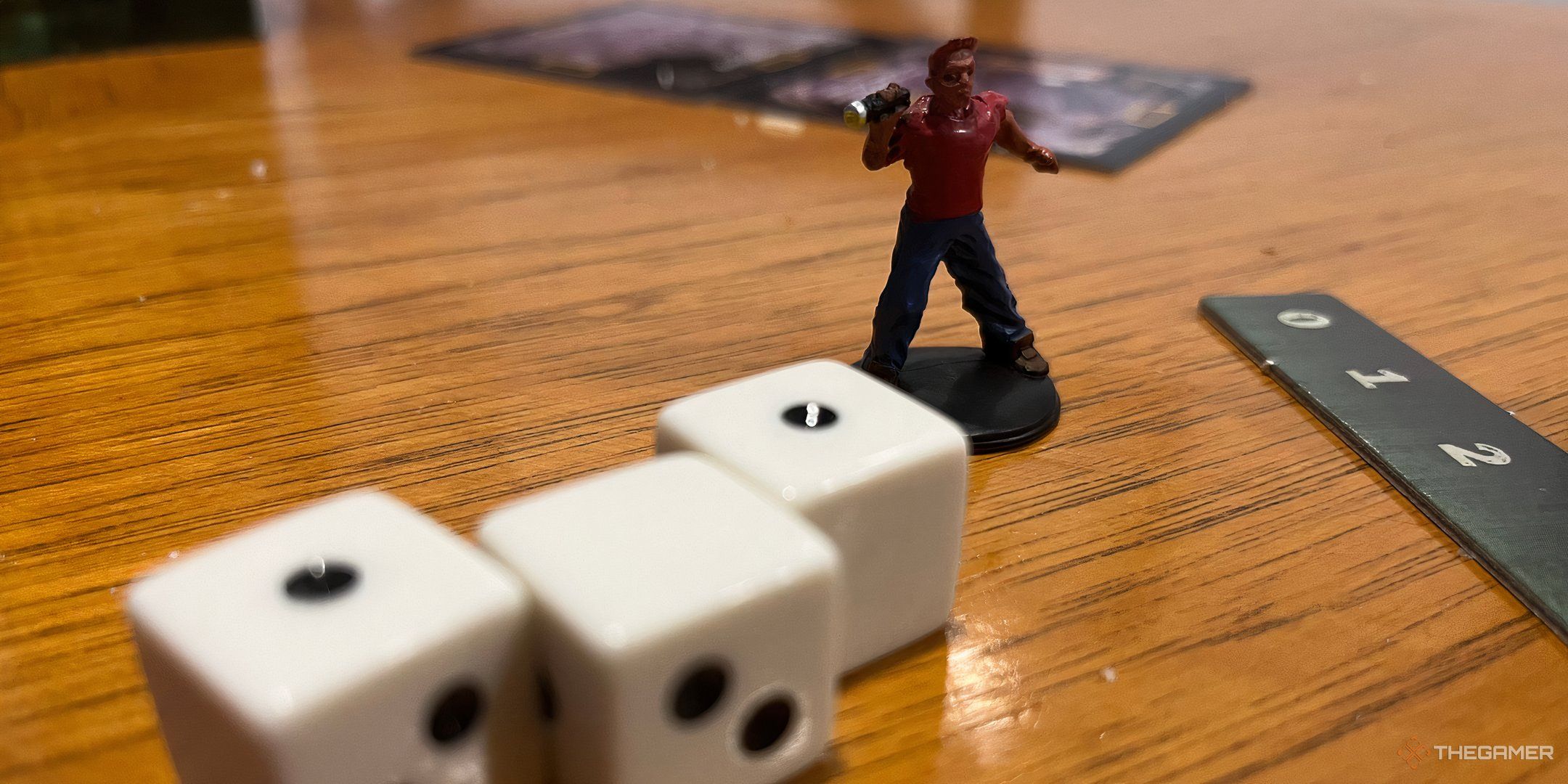 A character figure and dice for Betrayal at House on the Hill. 