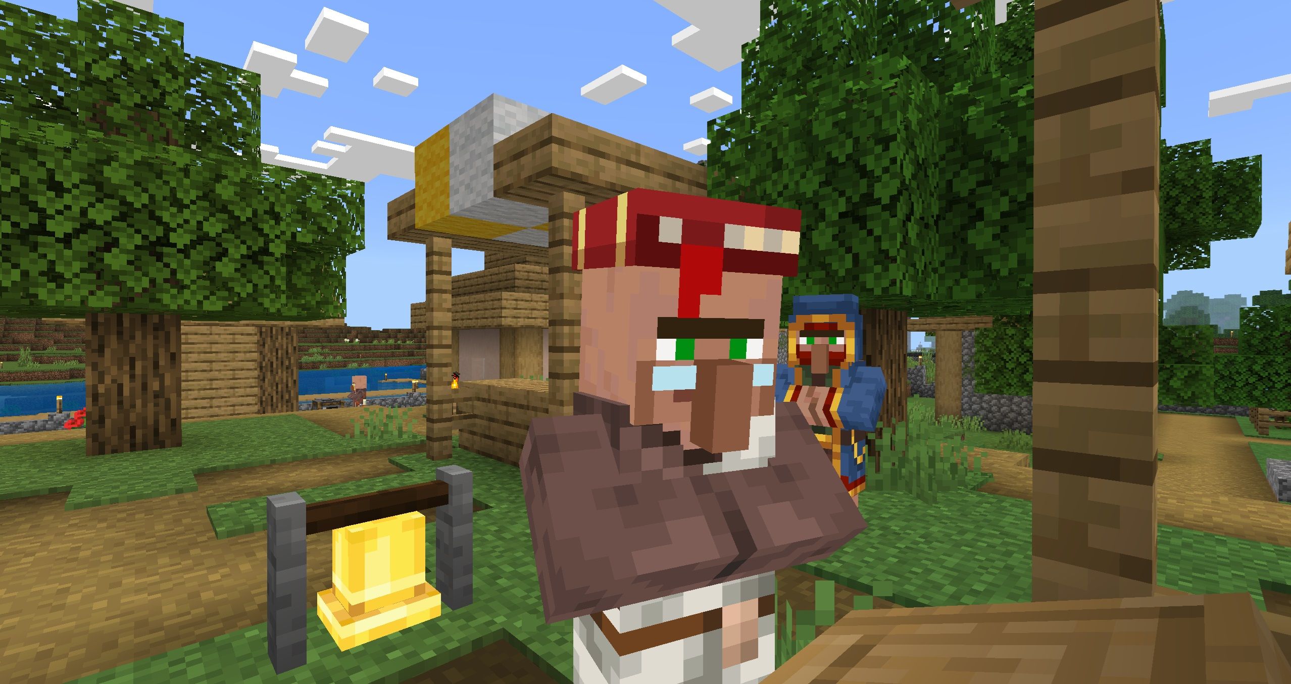 A Librarian villager at the town square with a Wandering Trader behind it in Minecraft.