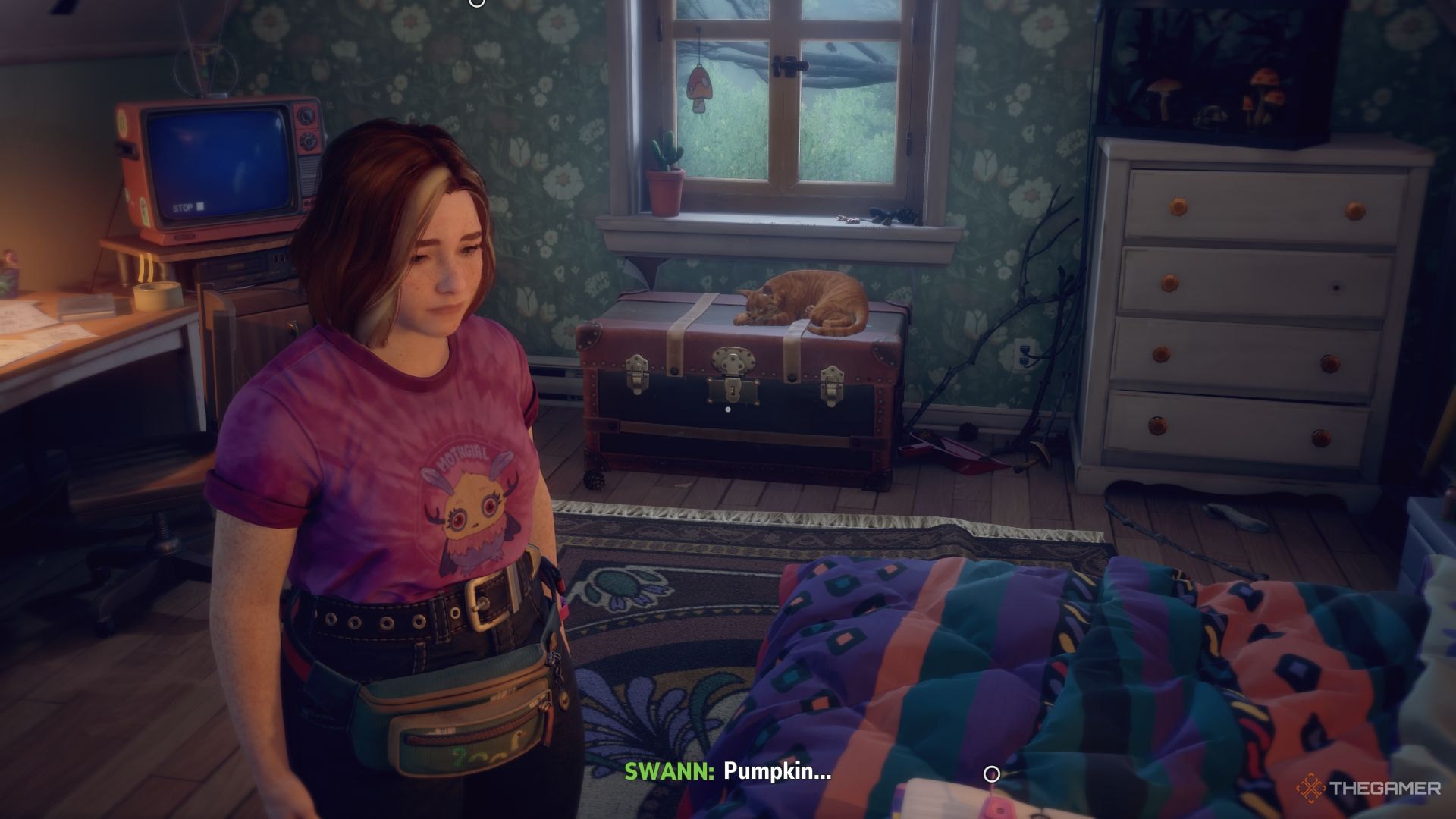 Swann in her bedroom talking to her cat.