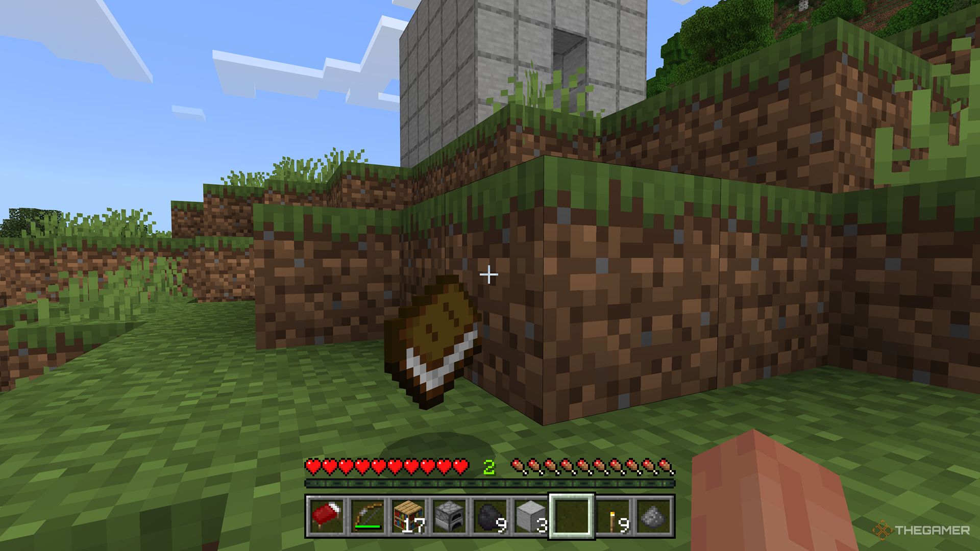 Minecraft screenshot of the player looking at a book that's on the floor.