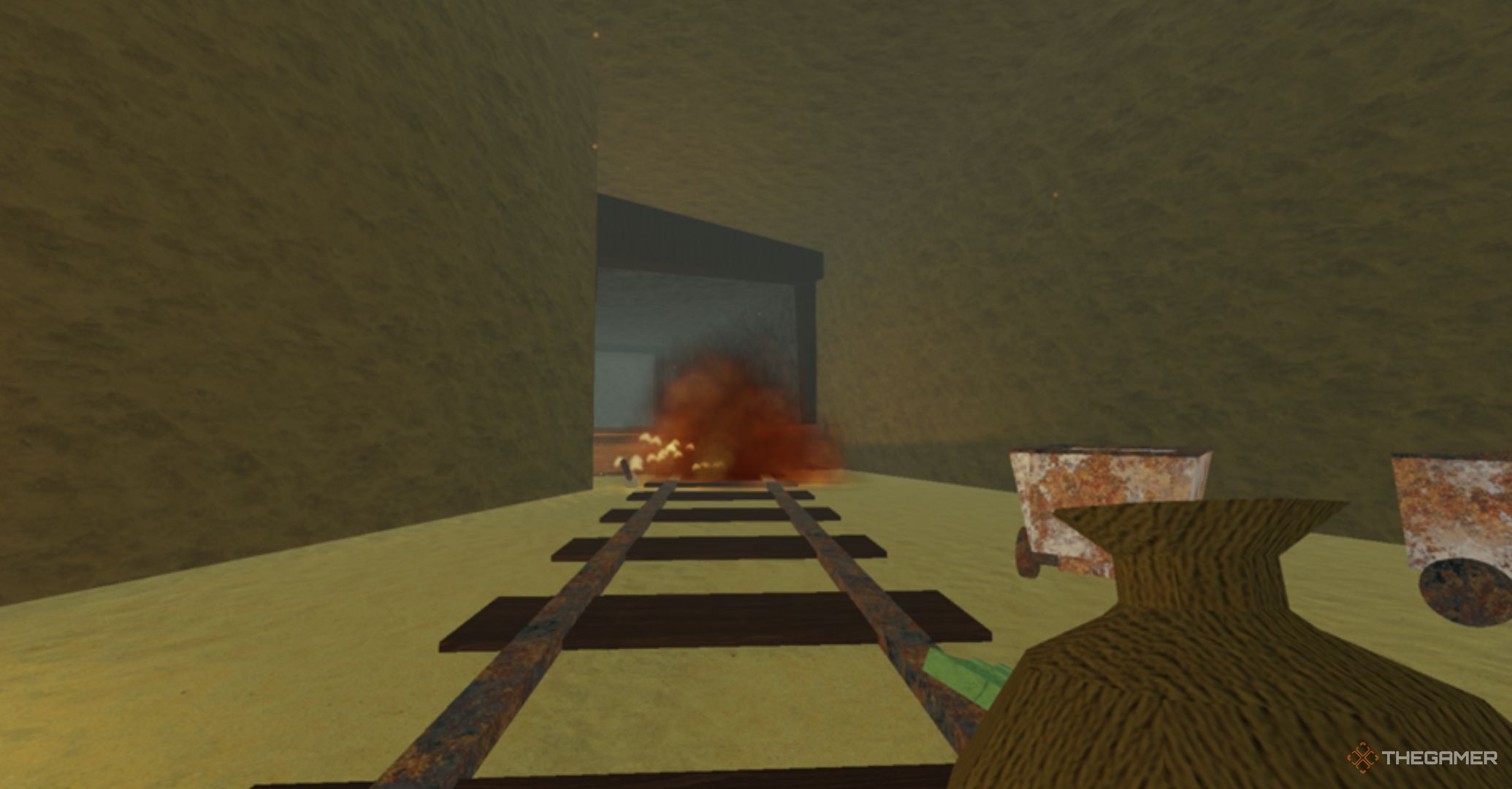 Roblox Dead Rails – entrance to an abandoned mine with mining carts and an explosion at the entrance.