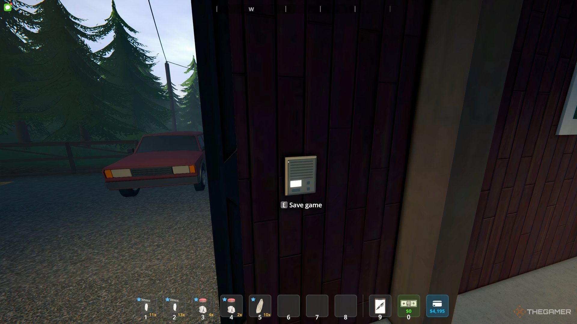 Player looking at the wall mount to save the game at the barn. There is a red car in the background off to the left. 