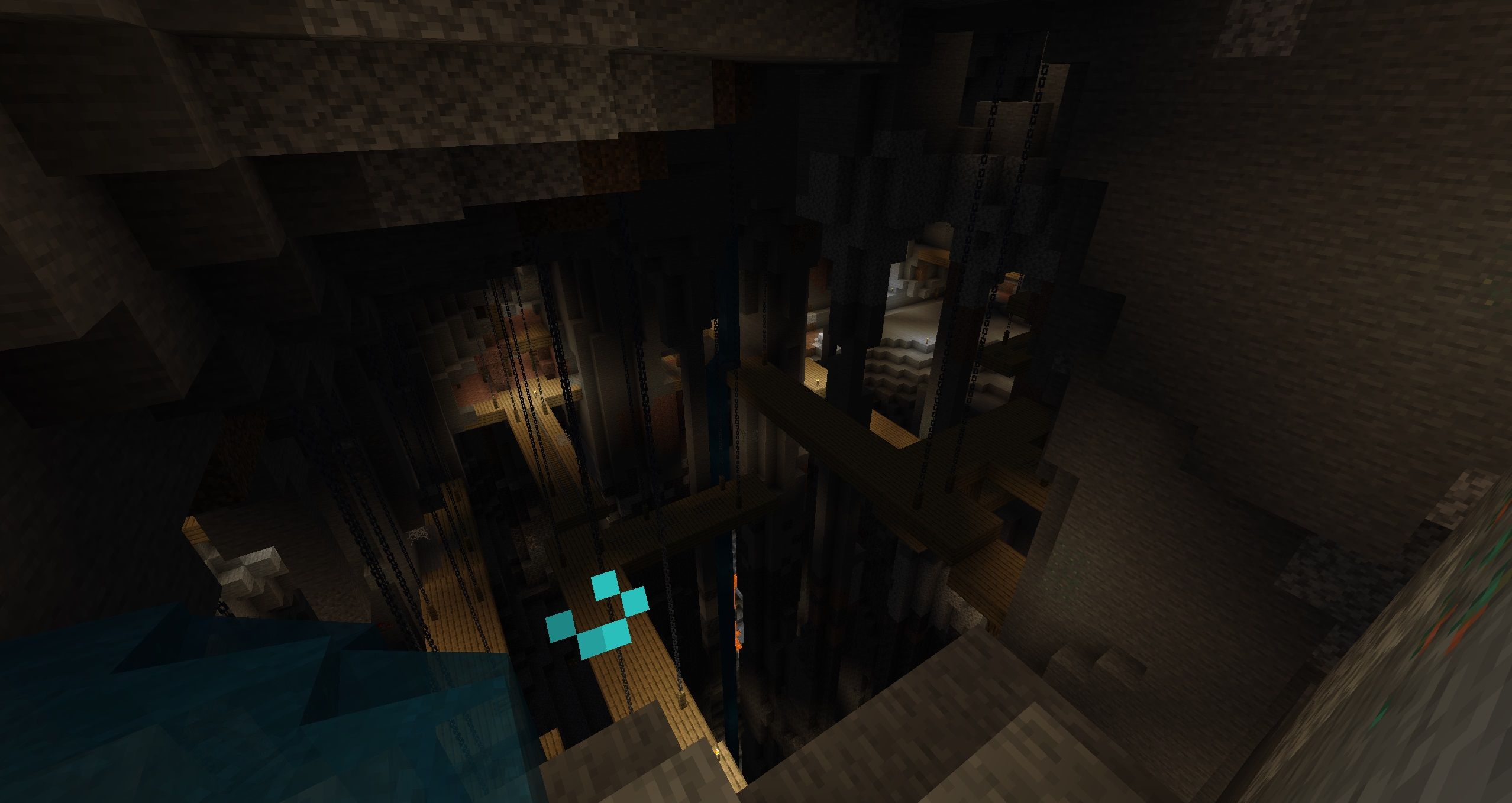 A view above a dark Mineshaft Dungeon, characterized by platforms hanging from thick chains in Minecraft.