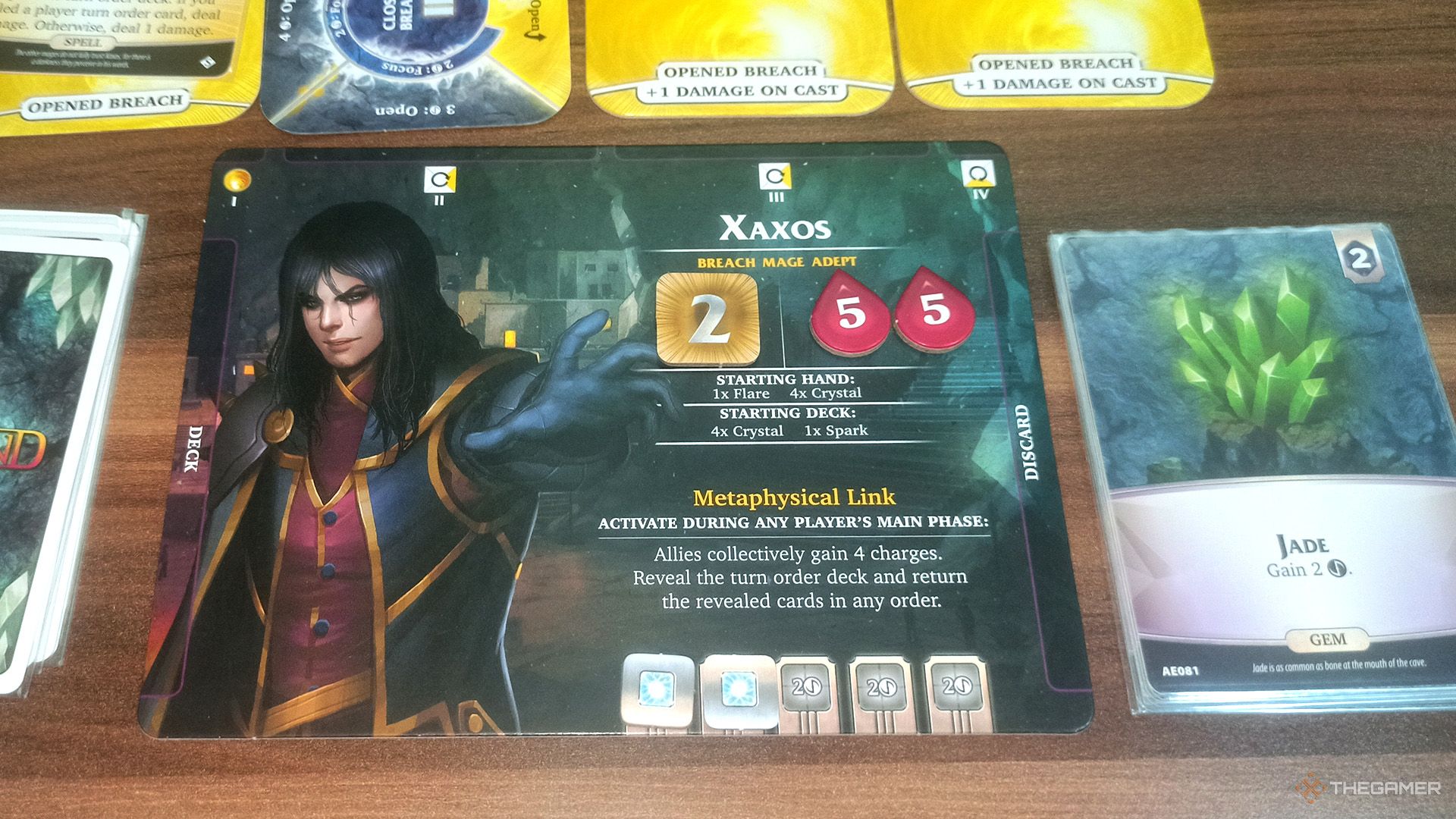 Xaxos's player mat and a Jade on the discard pile in Aeon's End.
