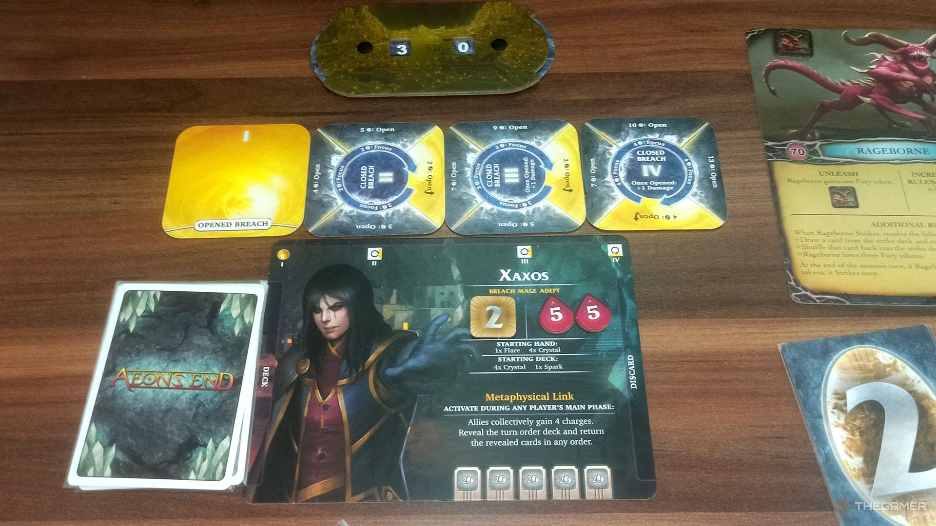 Xaxos's player mat, breaches and Gravehold's life dial in Aeon's End.
