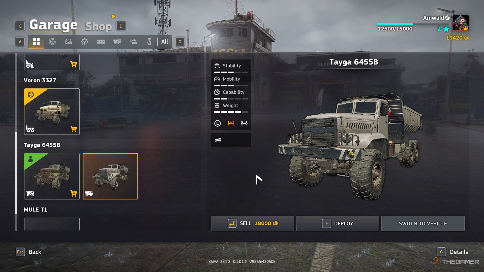 a standard tayga 6455B dump truck next to its rusty counterpart in the garage in roadcraft.