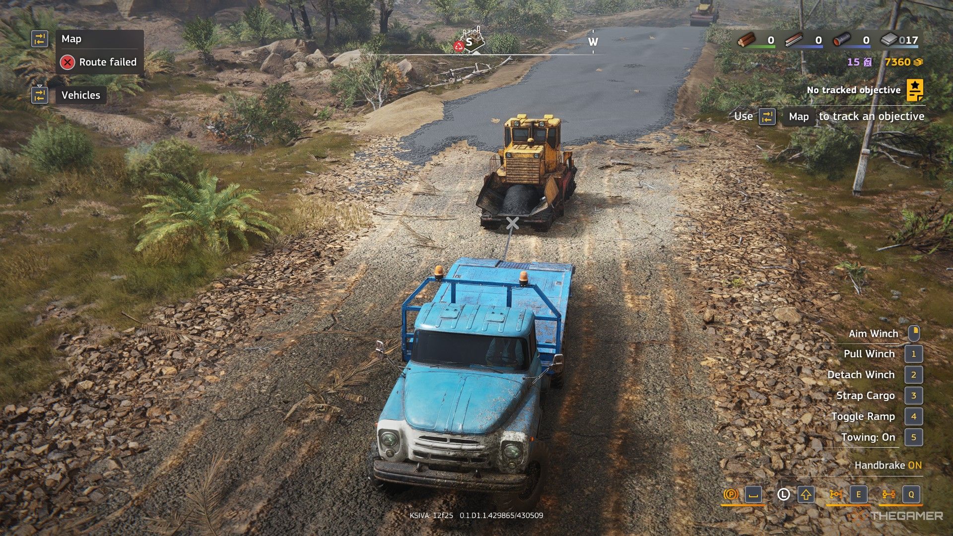 a transport truck uses a winch to load an asphalt paver in roadcraft.