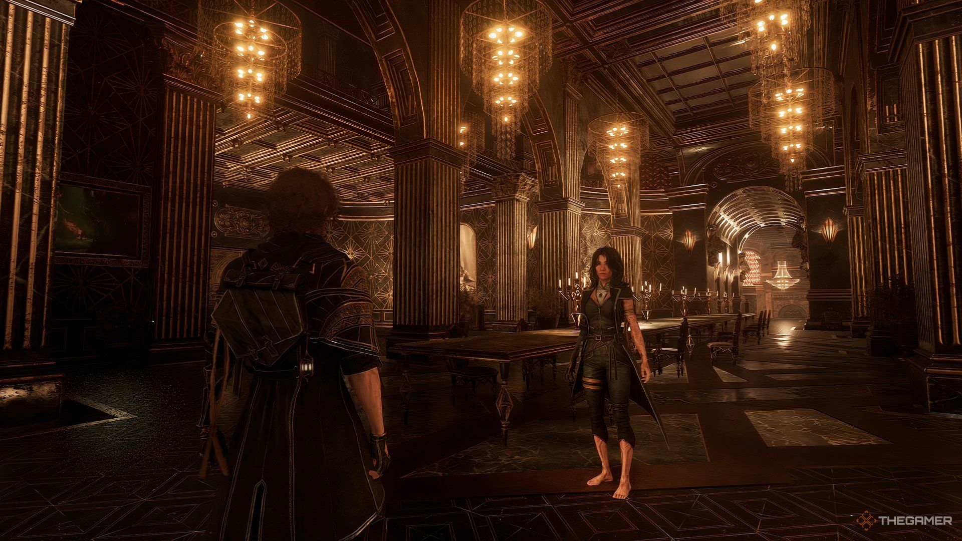 Gustave looking Luna in a large golden room in Clair Obscur: Expedition 33. There a low hanging lights above them and tabels behind Luna. 