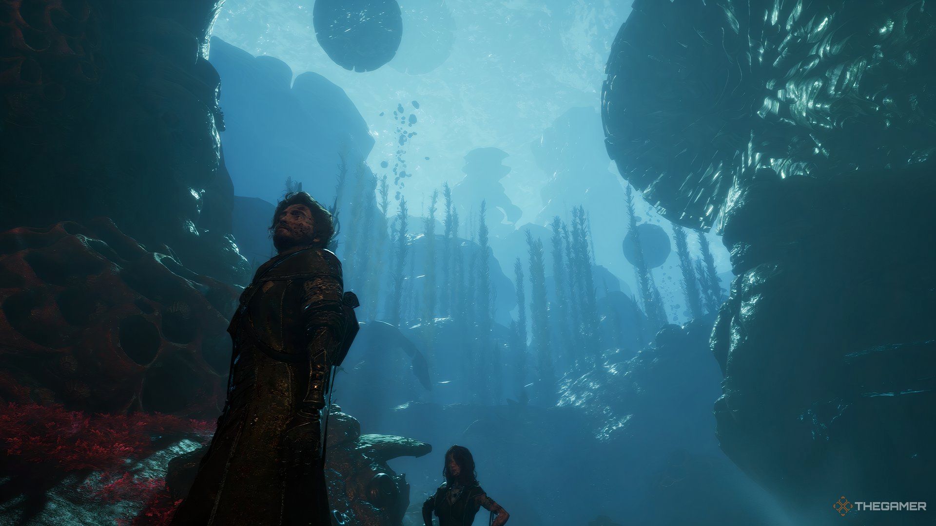 Gustave underneath water with floating objects behind him in Clair Obscur: Expedition 33. Lune is also behind him. 