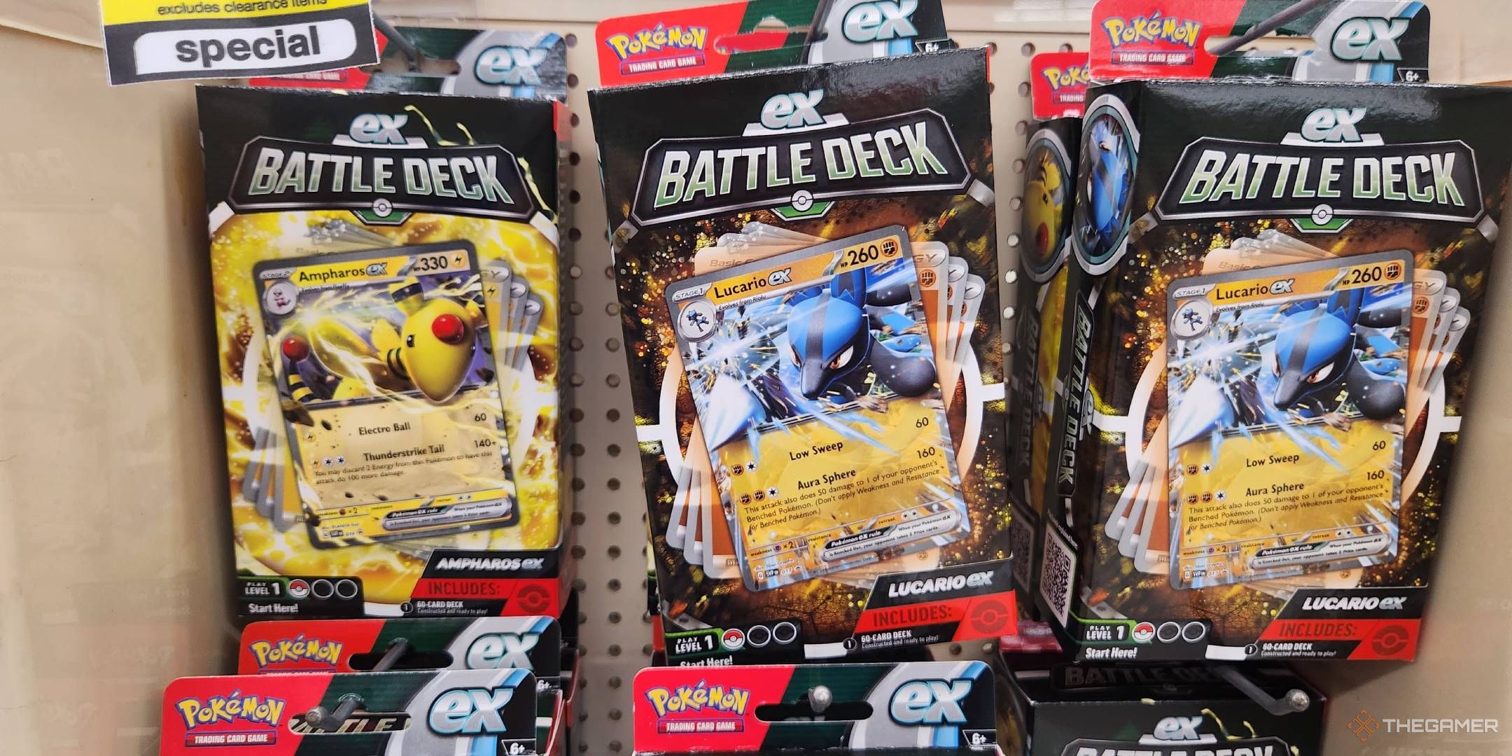 A CVS Pharmacy display case loaded with Ampharos ex and Lucario ex Battle Decks for the Pokemon TCG.