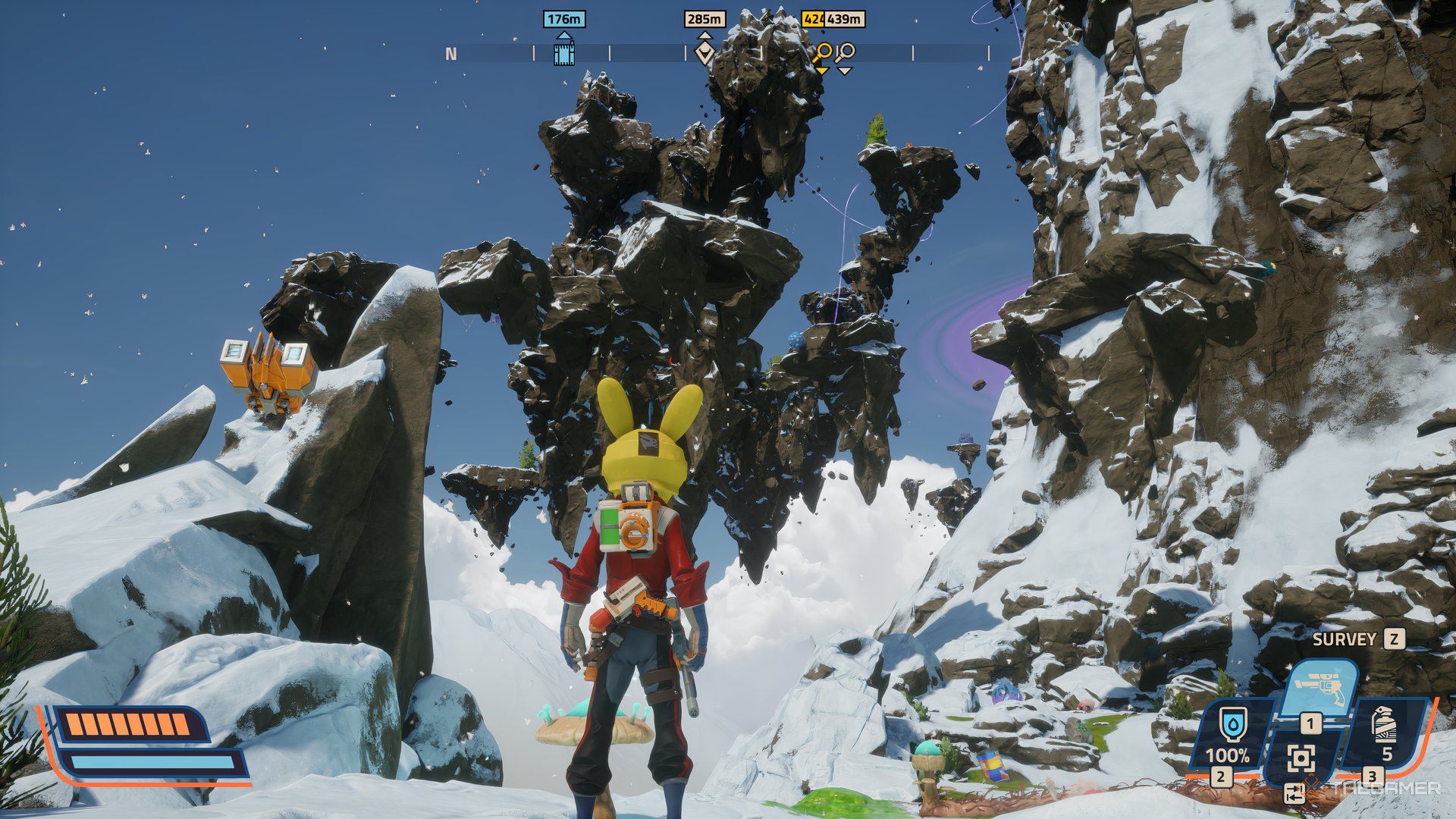 Plater looking at a large rock structure that is floating in the air in Revenge of the Savage Planet. All around it is snow. 