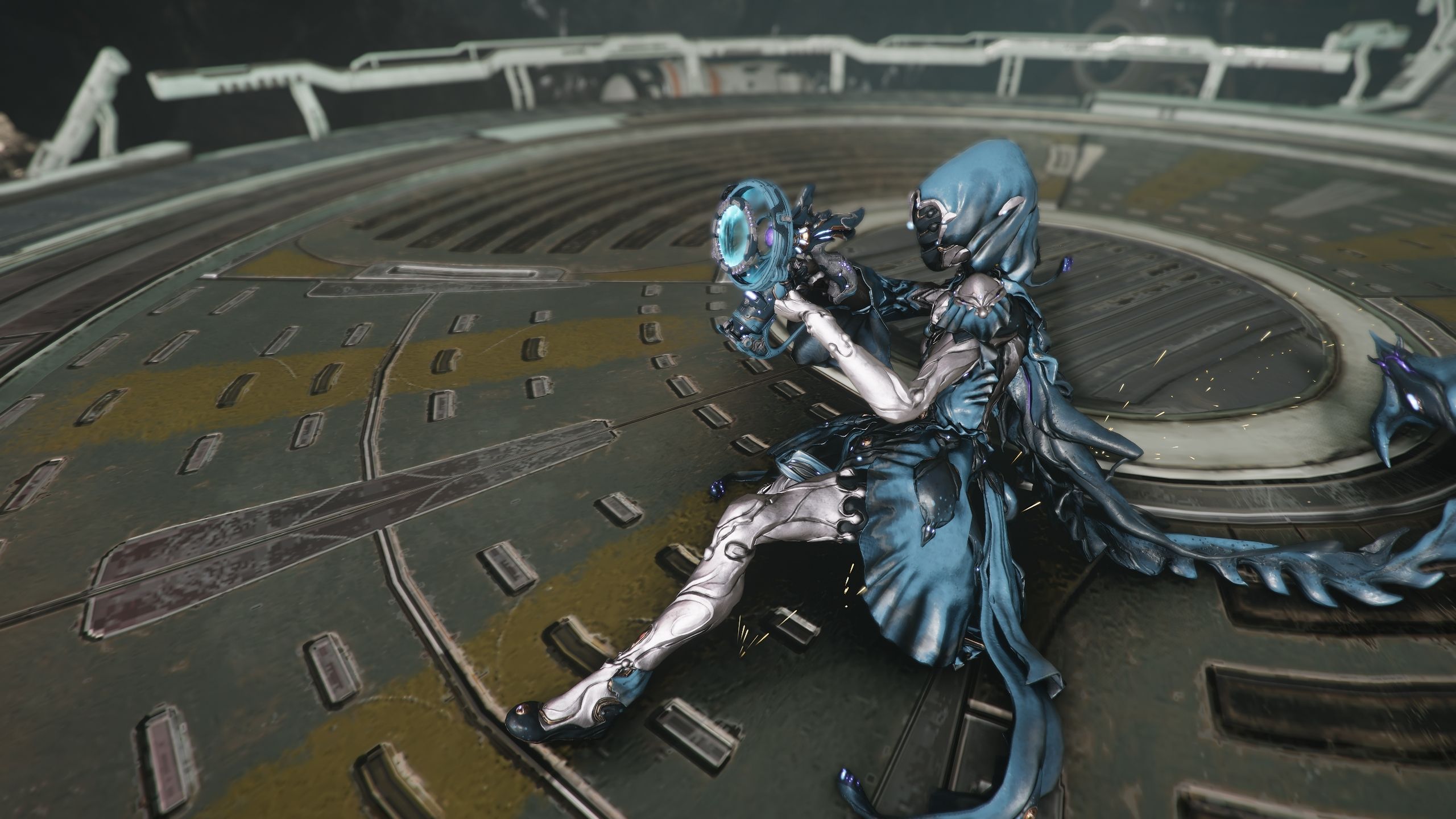 Yareli sliding on the floor pointing the Kompressa forward in Warframe.