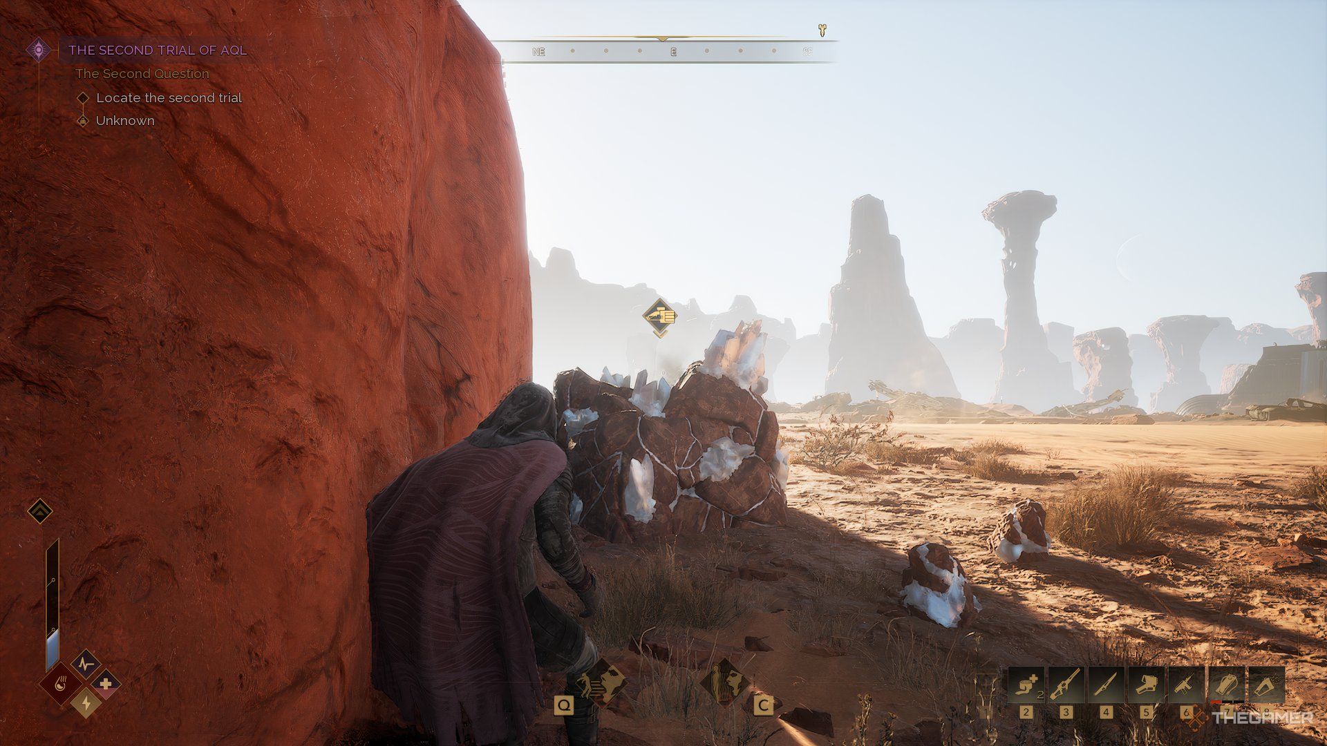 Player standing right infront of Carbon stone pile in Dune: Awakening. There are larger rock pillars in the background. 