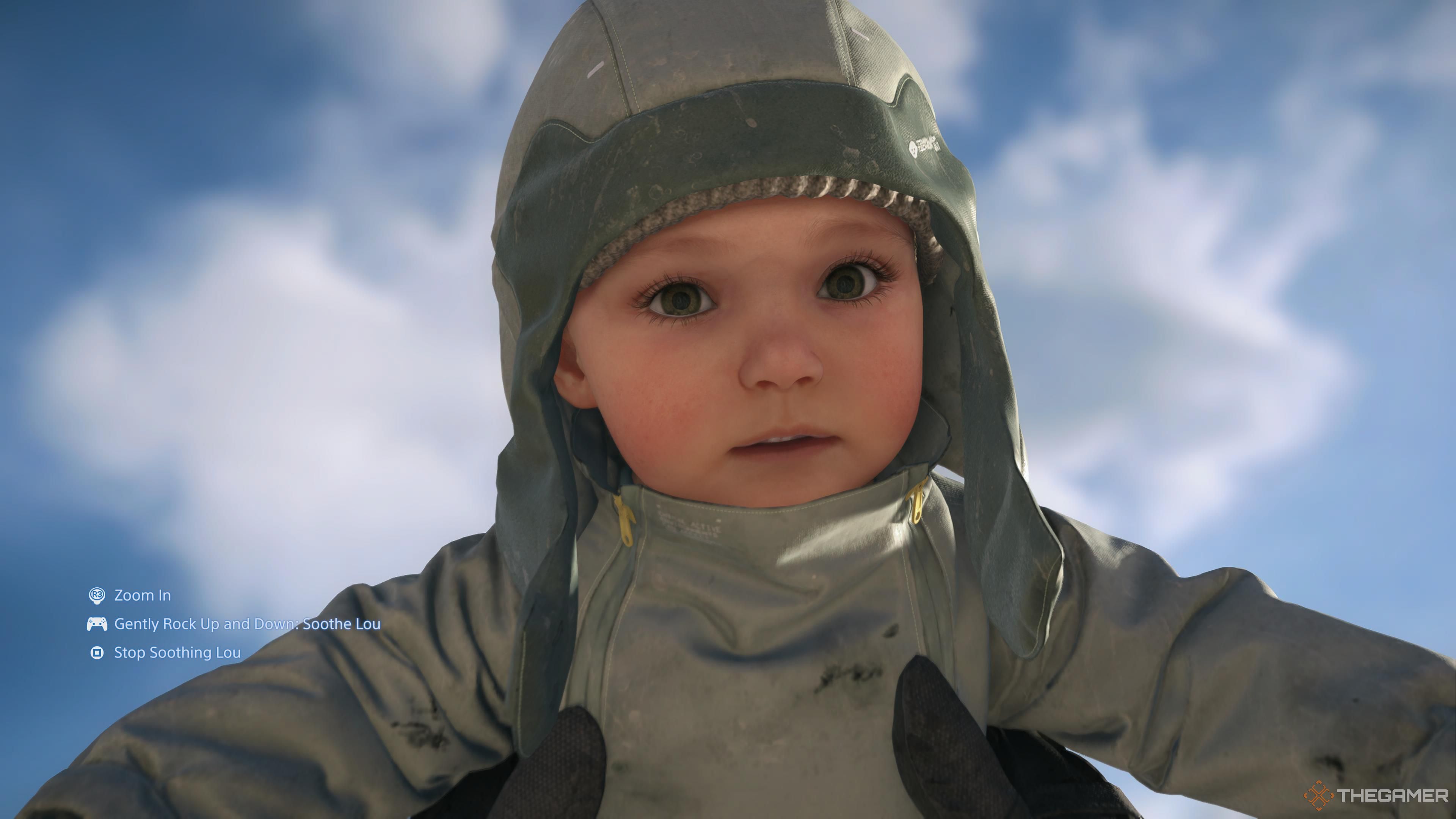 Lou as a grown up baby being soothed in Sam's hands in death stranding 2: on the beach.