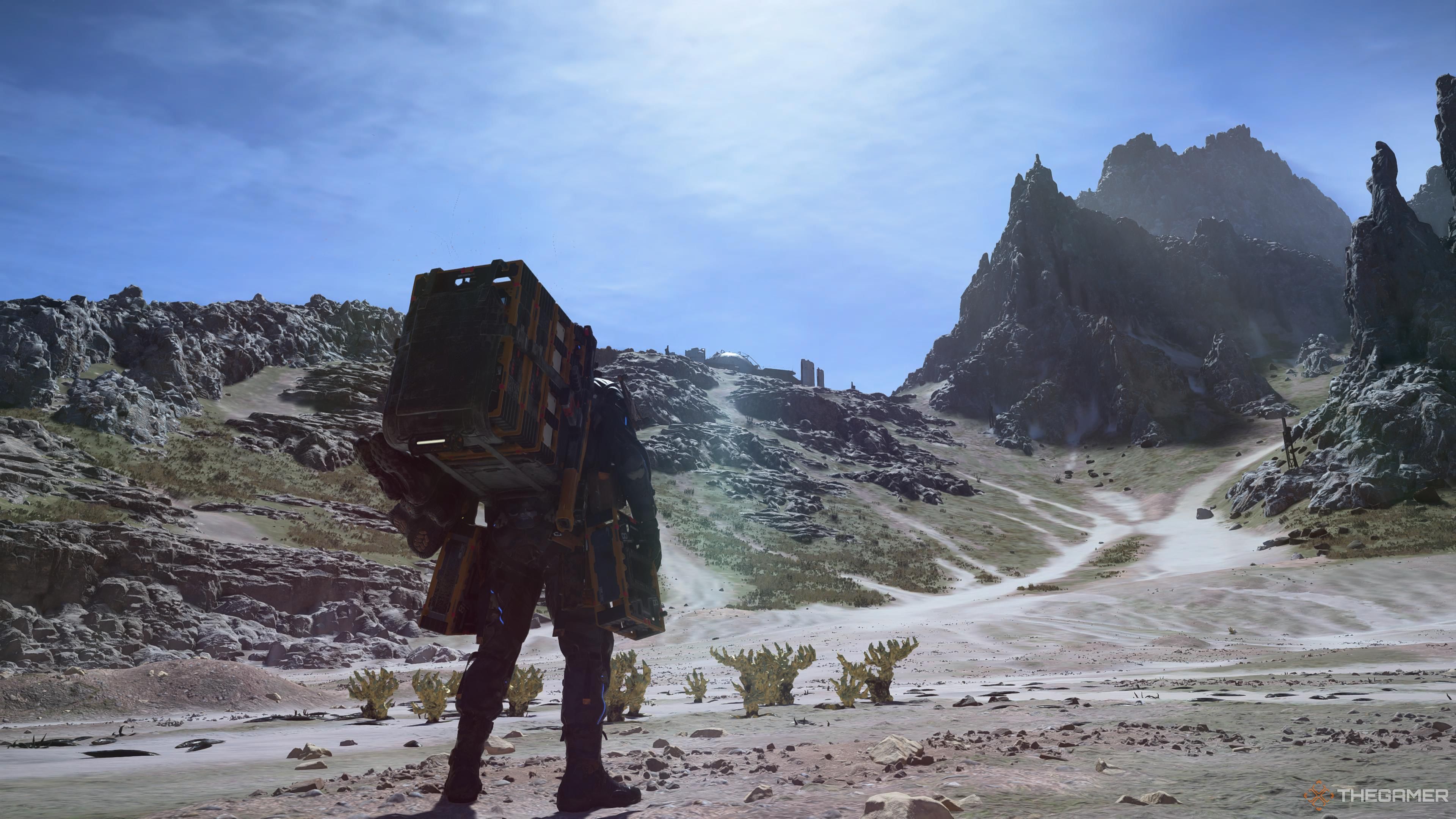 Sam standing looking at a steep hill with chiral crystals ahead of him.