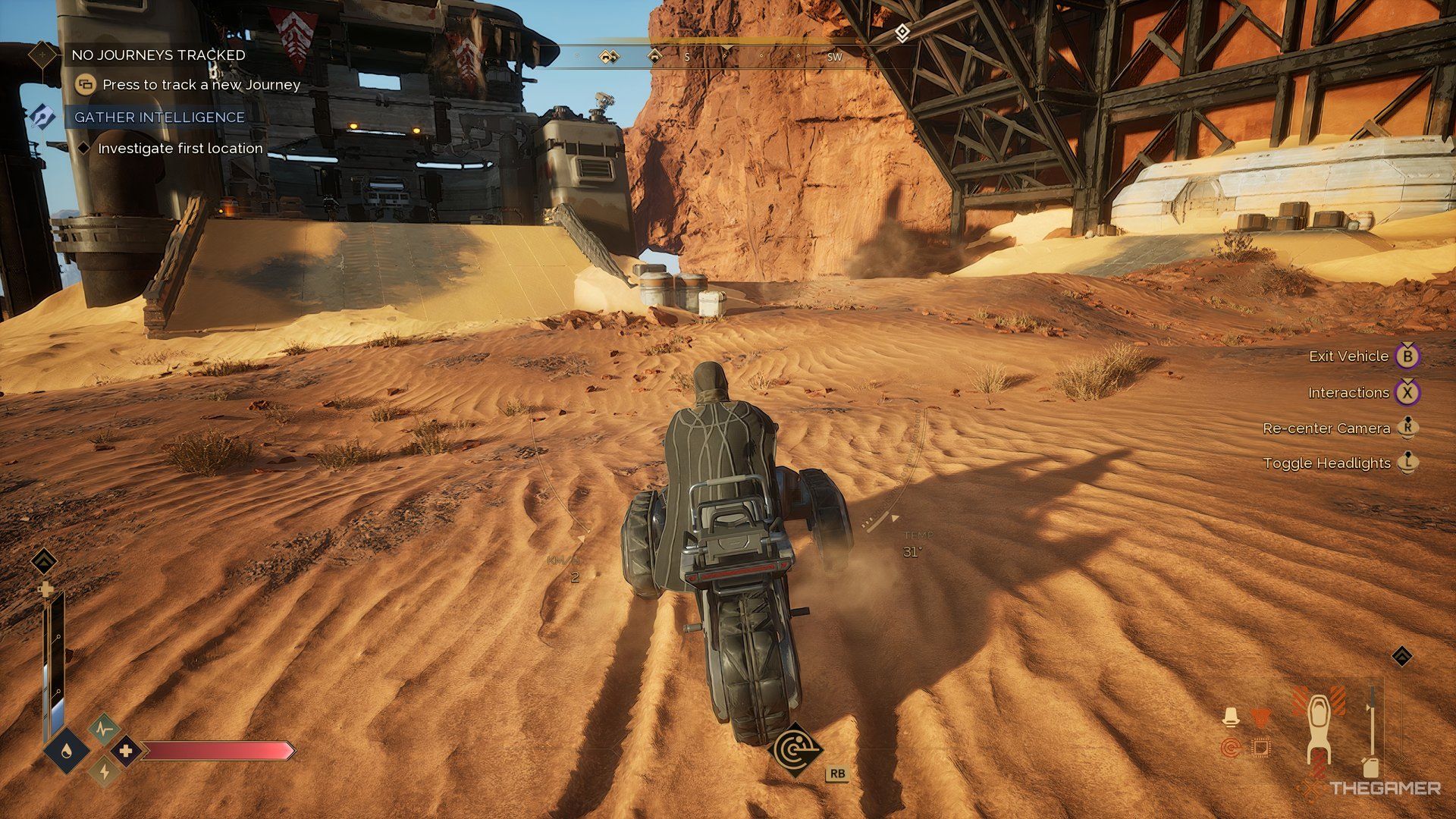 Player on a sandbike in Dune: Awakening with a Buggy in a structure in front of him. 