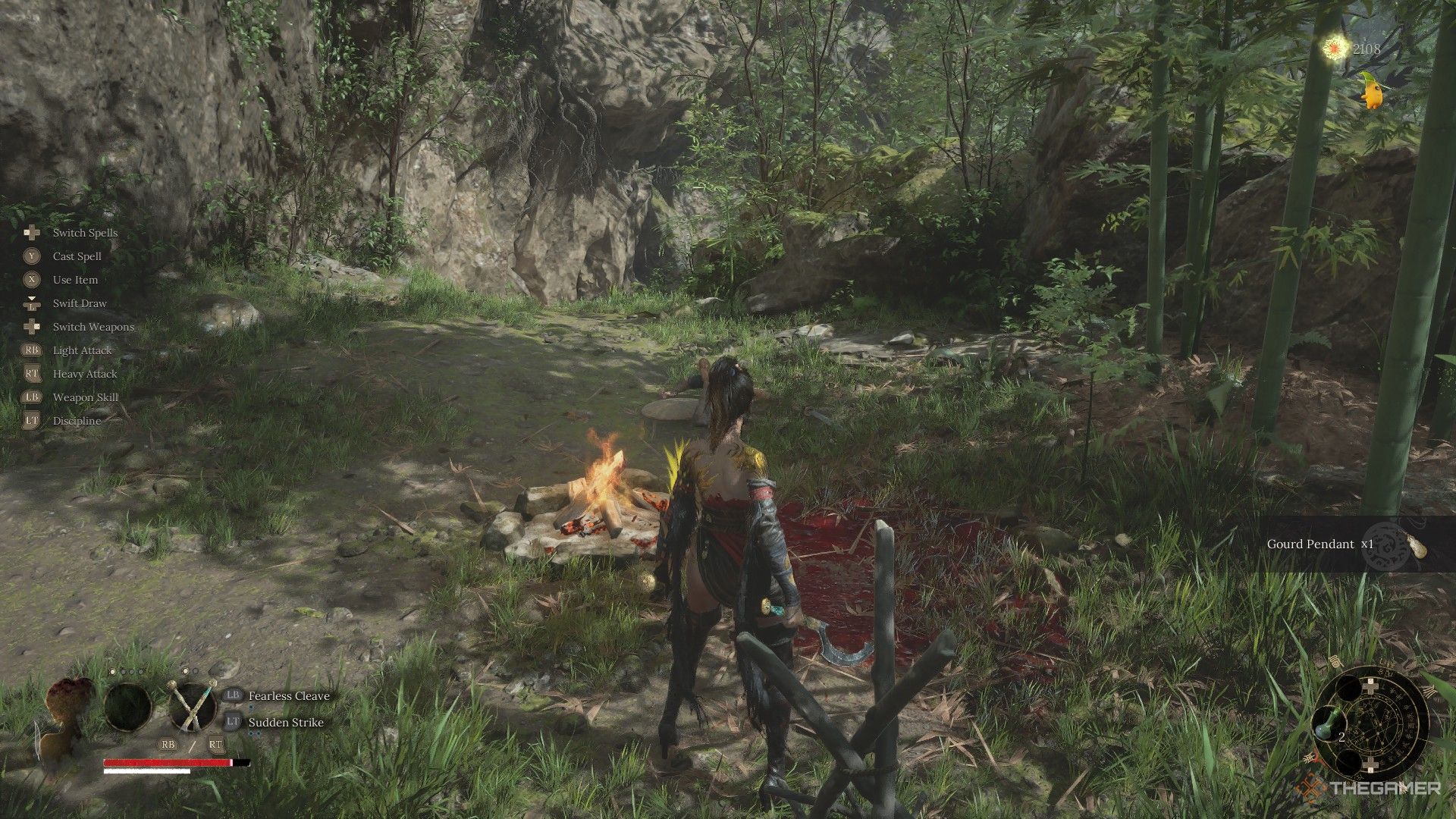 Wuchang receives the Gourd Pendant from a dead bandit by the campfire in Wuchang: Fallen Feathers.