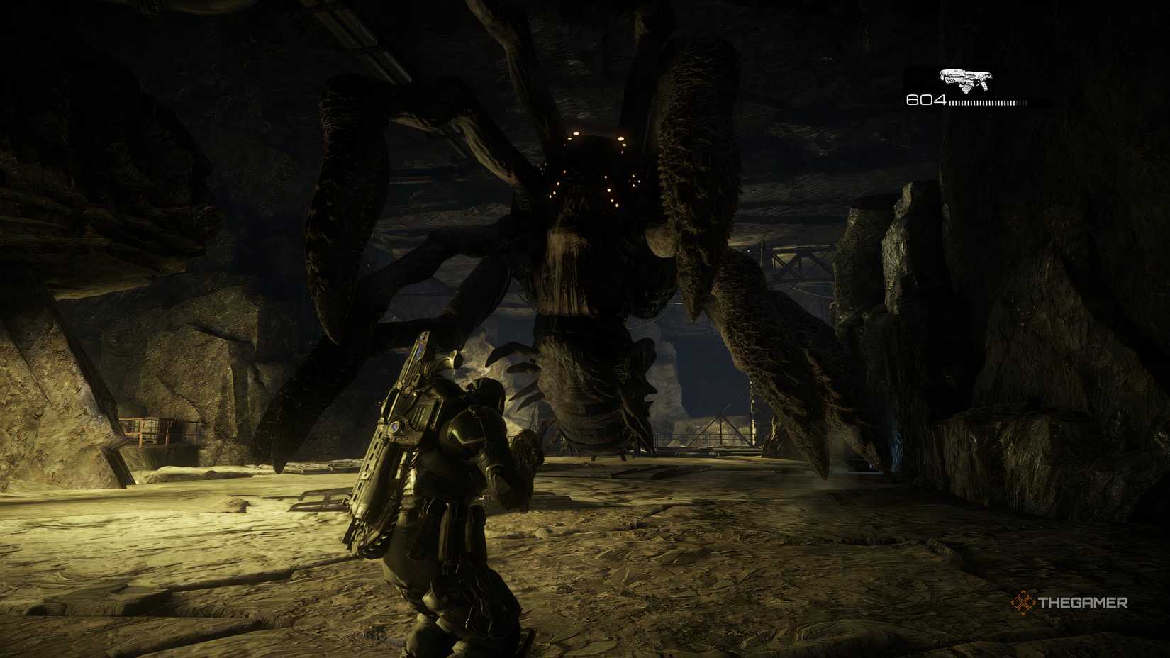 The Corpser claws out of way and showing its face in Gears of War: Reloaded. The player is standing infront of it. 