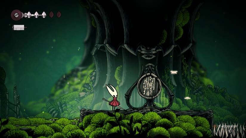 Hornet finds a sign board below the Silkspear Herrah statue in Hollow Knight: Silksong.