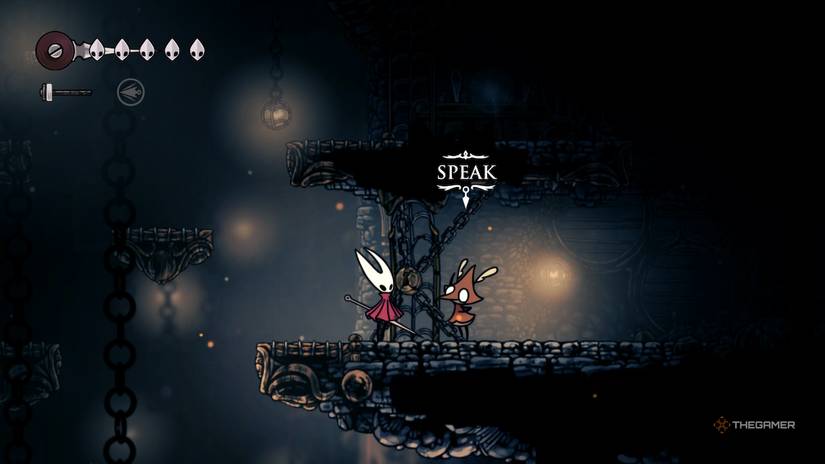 Grindle is trapped behind a cell door in The Marrow as Hornet speaks to him in Hollow Knight: Silksong.