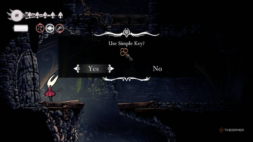 Hornet uses the Simple Key to unlock the Wormways in Hollow Knight: Silksong.