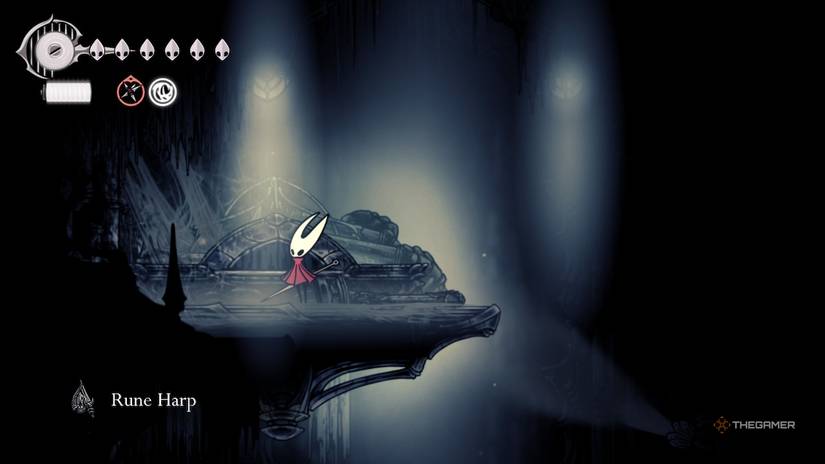 Hornet picks up the Rune Harp in Hollow Knight: Silksong.
