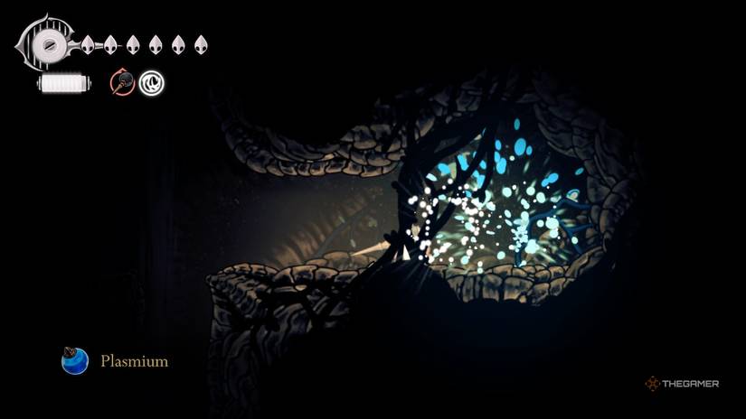 Hornet takes the plasmium from a deposit in the upper Wormways in Hollow Knight: Silksong.