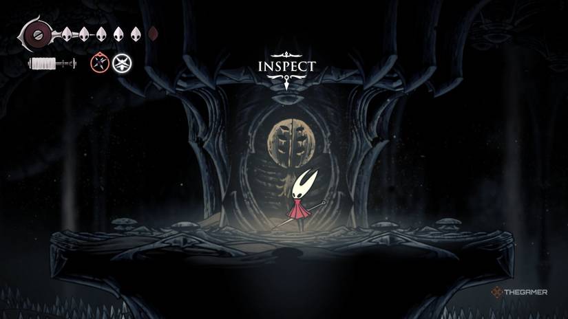 Hornet inspects the Herrah statue in Weavenest Karn in Hollow Knight: Silksong.