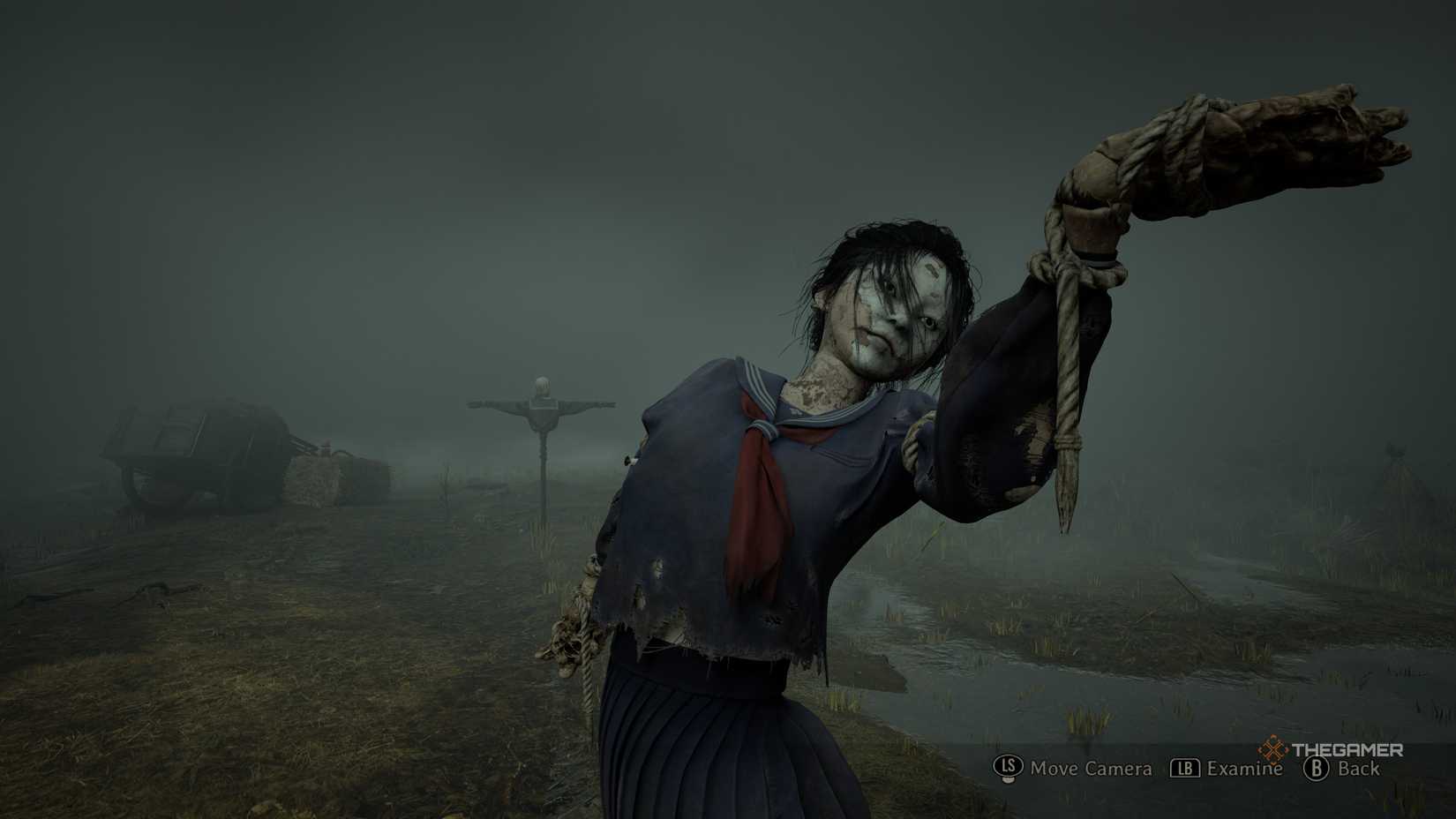 A scarecrow in a school uniform being examined in silent hill f.