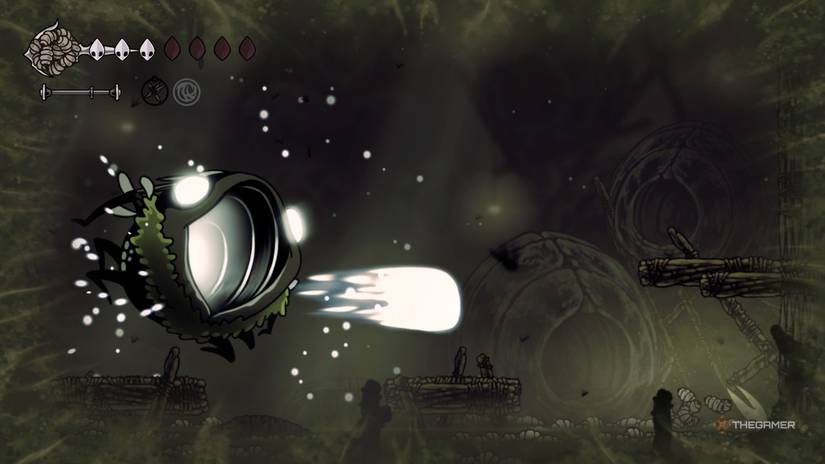 Groal uses his Vengeful Toad attack while Hornet swims in maggots in Hollow Knight: Silksong.