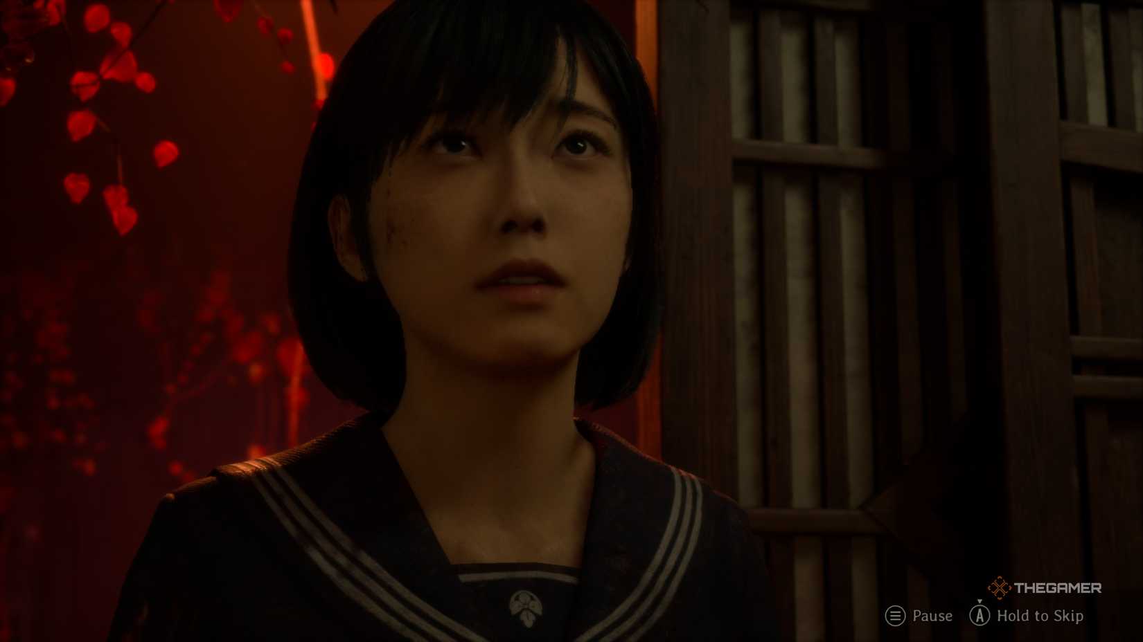 Hinako looking up as she passes through a door in Silent Hill f.