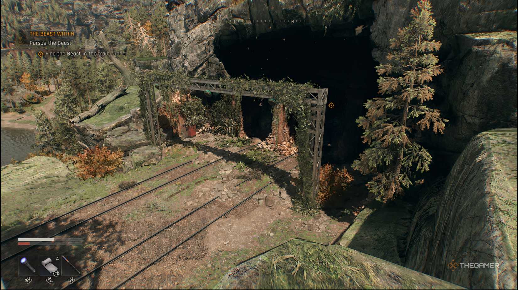 The player looking at a set of train tracks that go into a cave in Dying Light: The Beast.