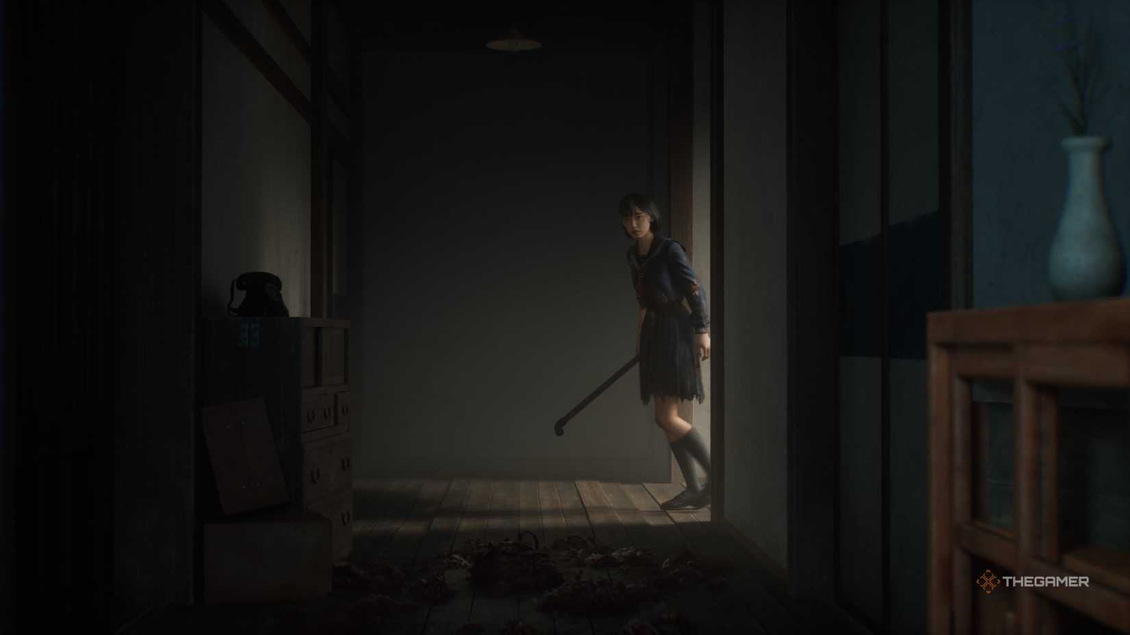 The protagonist entering a building with a crowbar in Silent Hill f.