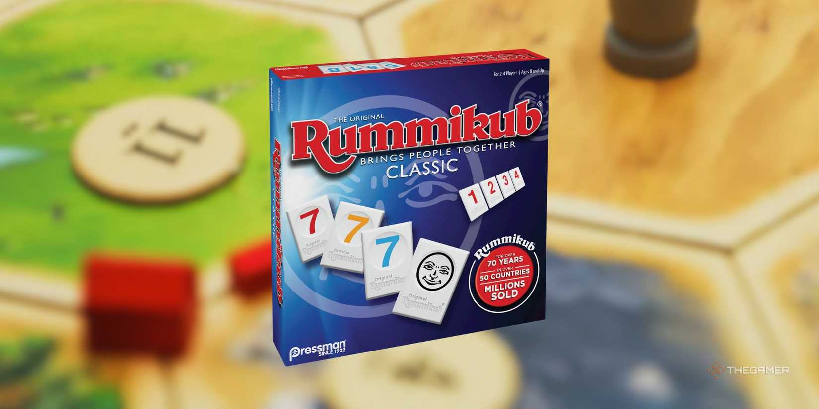 Rummikub in front of a blurred image of a Catan board.