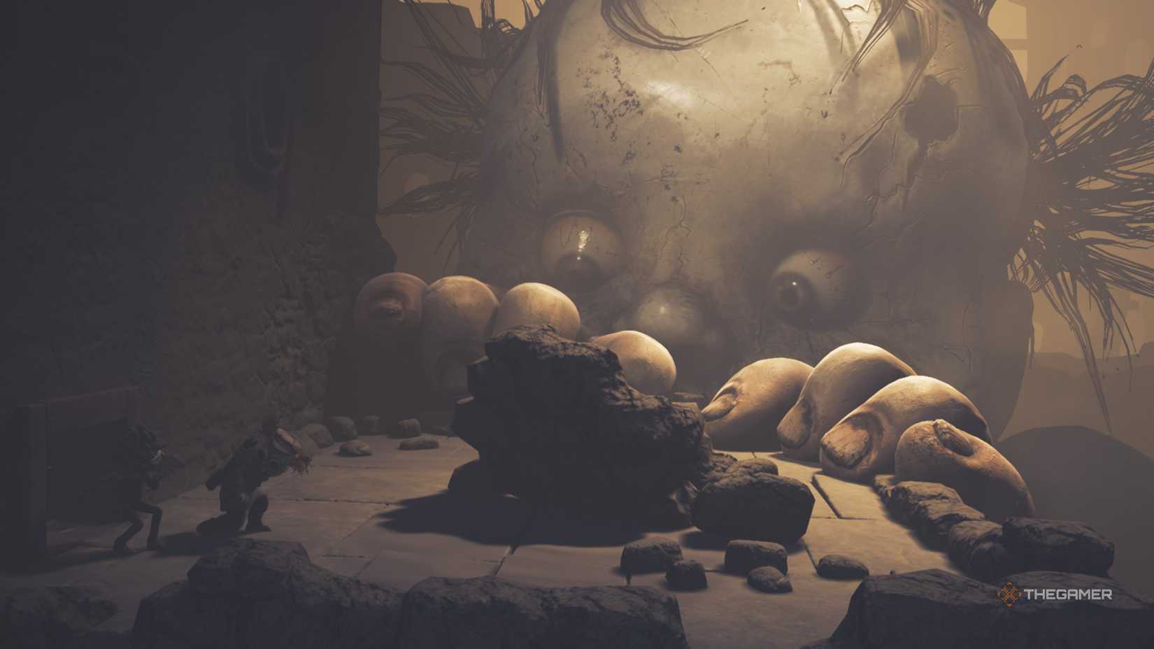 Monster Baby peeking over a ledge at Low and Alone in Little Nightmares 3.