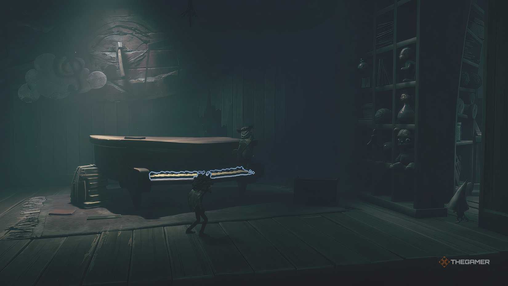 Alone standing on a piano looking at a secret room in Little Nightmares 3.