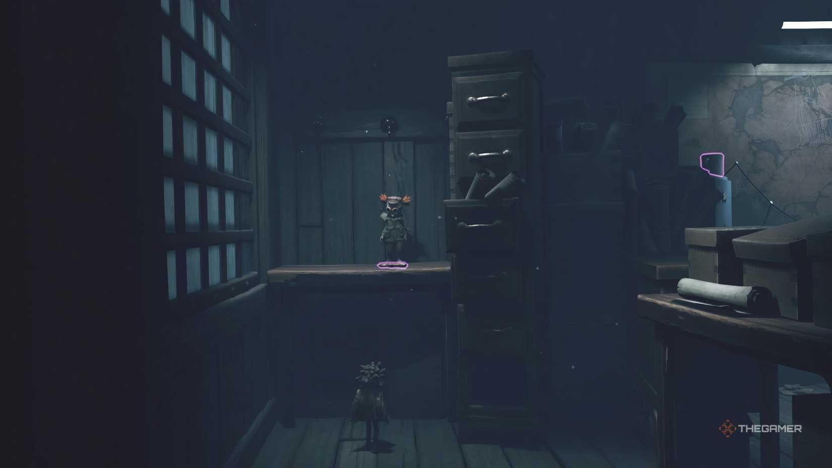 Alone grabbing a key off a hook in Little Nightmares 3.